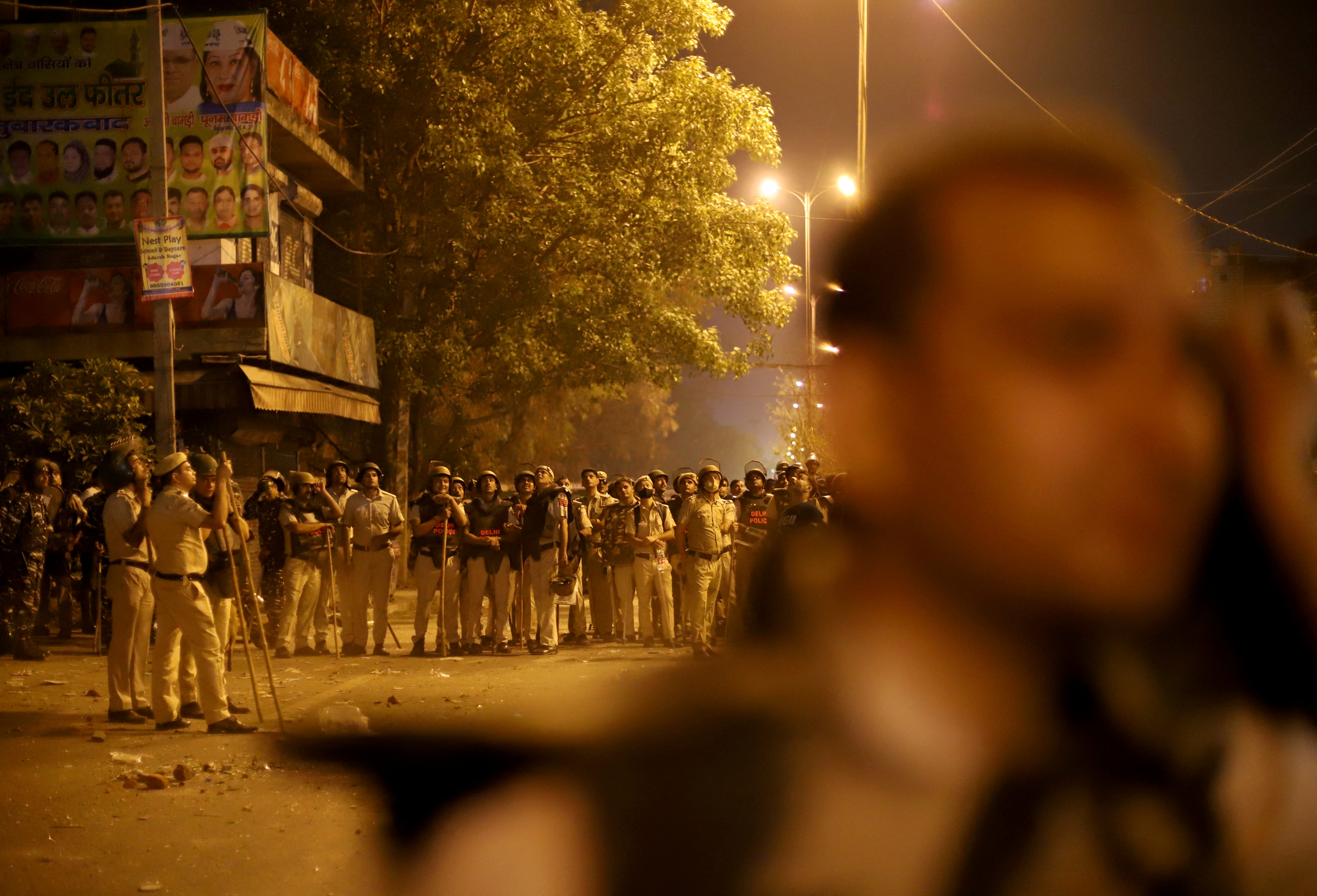 Police personnel stand guard after clashes broke out during a Hindu religious procession in Jahangirpuri area of New Delhi