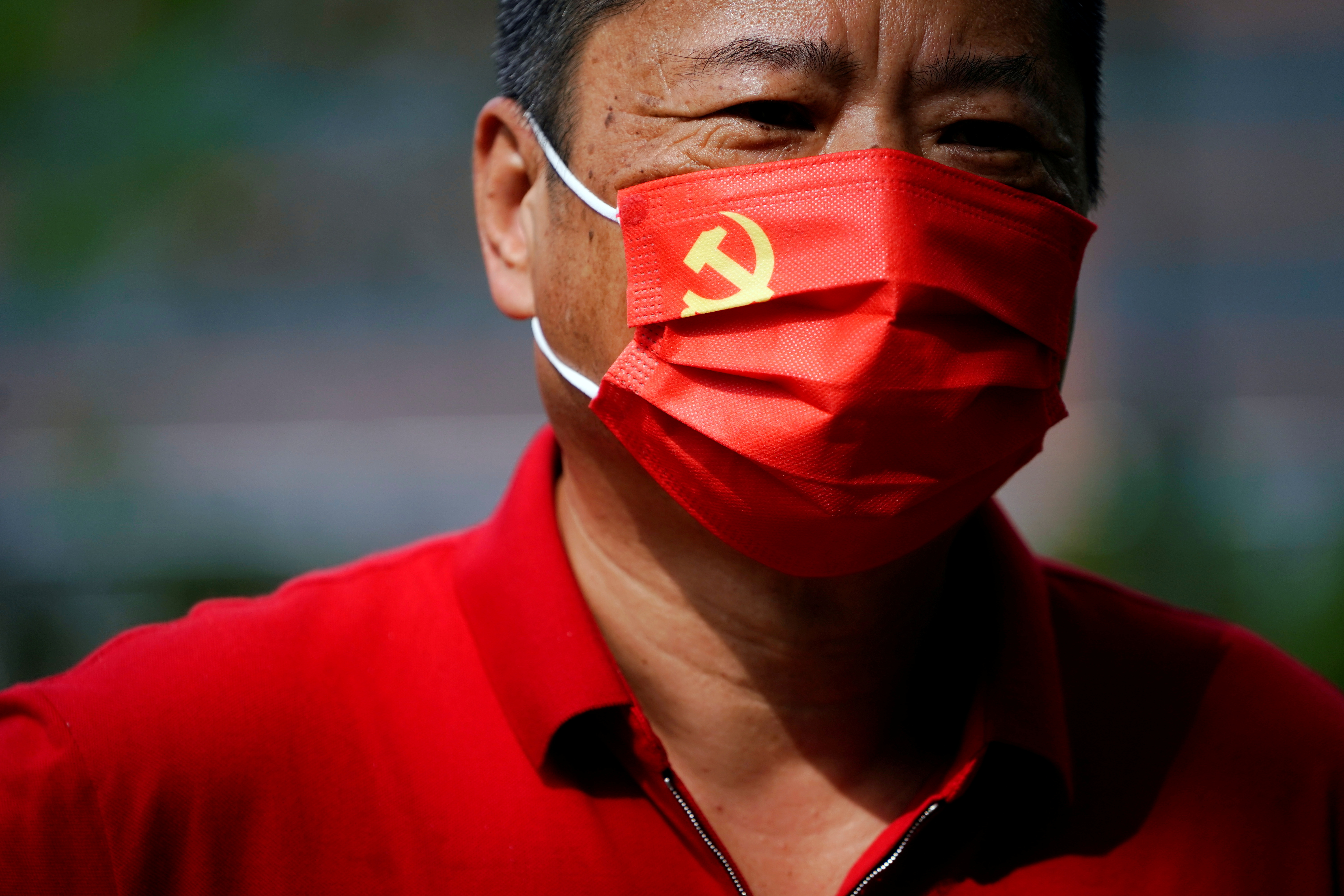 A man, wearing a face mask with the Chinese Communist Party emblem following the coronavirus disease (COVID-19) outbreak, visits the Memorial of the First National Congress of the Communist Party of China on the 100th founding anniversary of the party in Shanghai, China July 1, 2021. REUTERS/Aly Song     TPX IMAGES OF THE DAY - RC2CBO9PJFDL