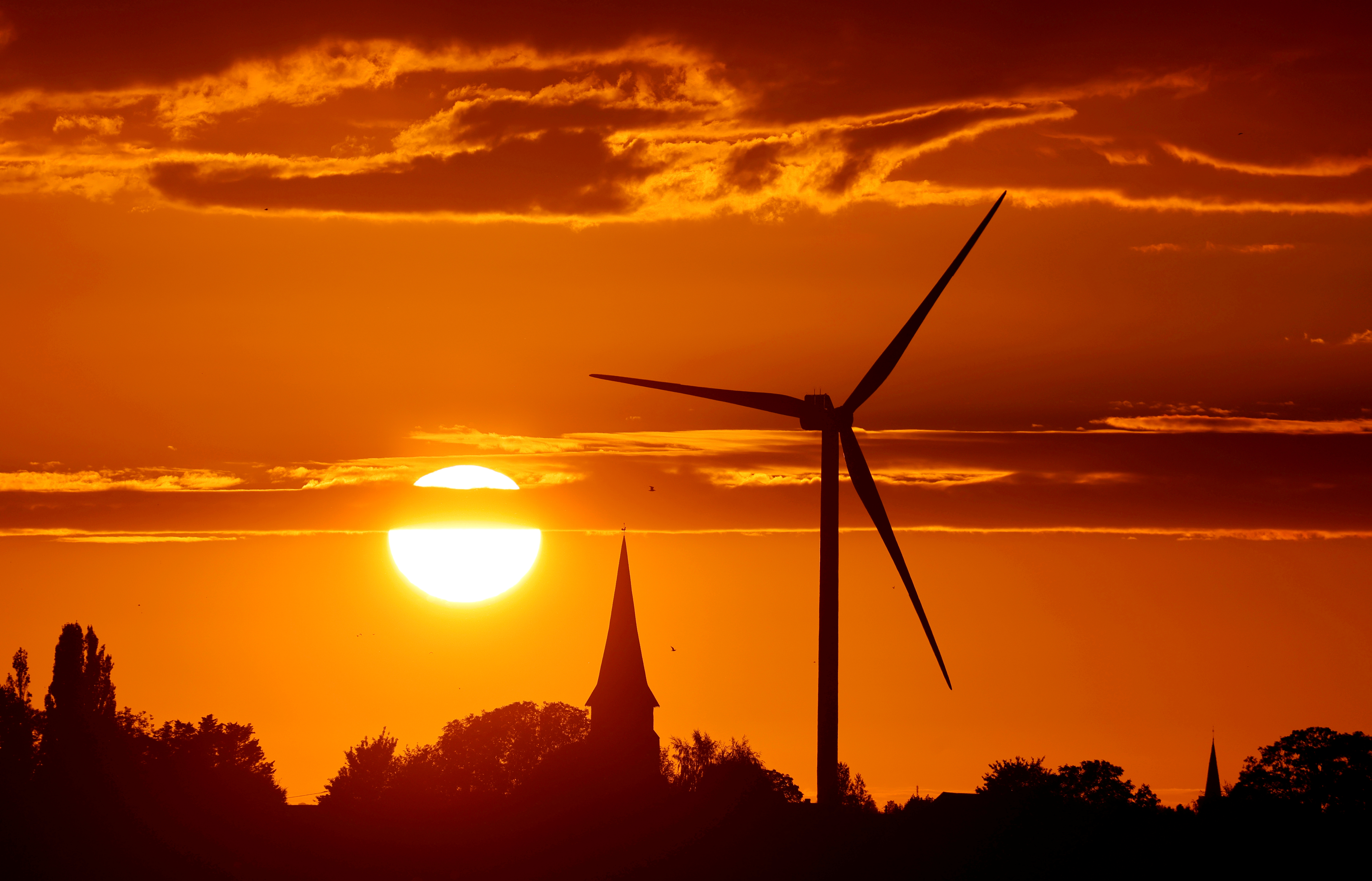 FILE PHOTO: A power-generating windmill turbine is pictured during sunset at a renewable energy park in Ecoust-Saint-Mein, France