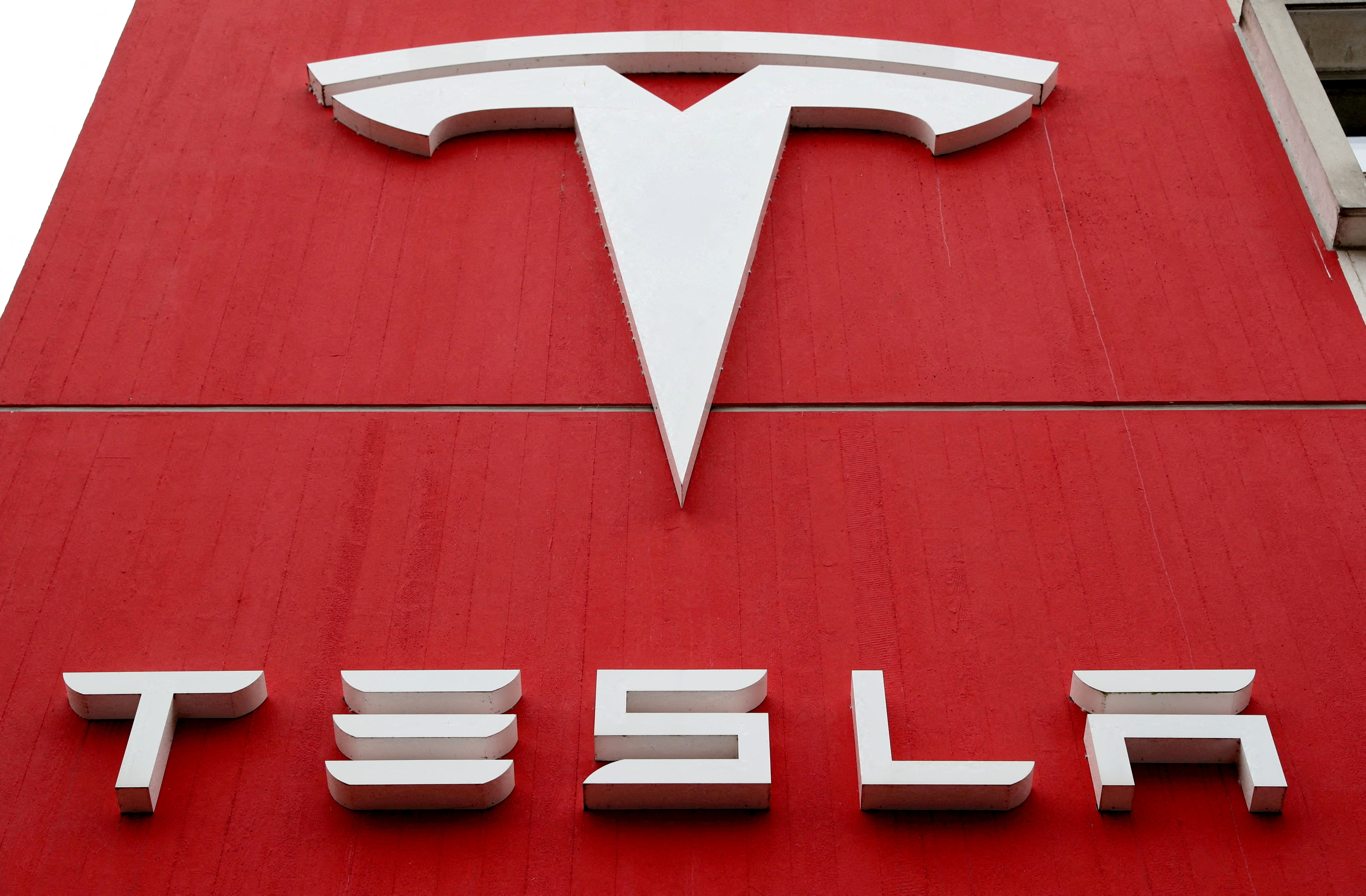 The logo of car manufacturer Tesla is seen in Bern