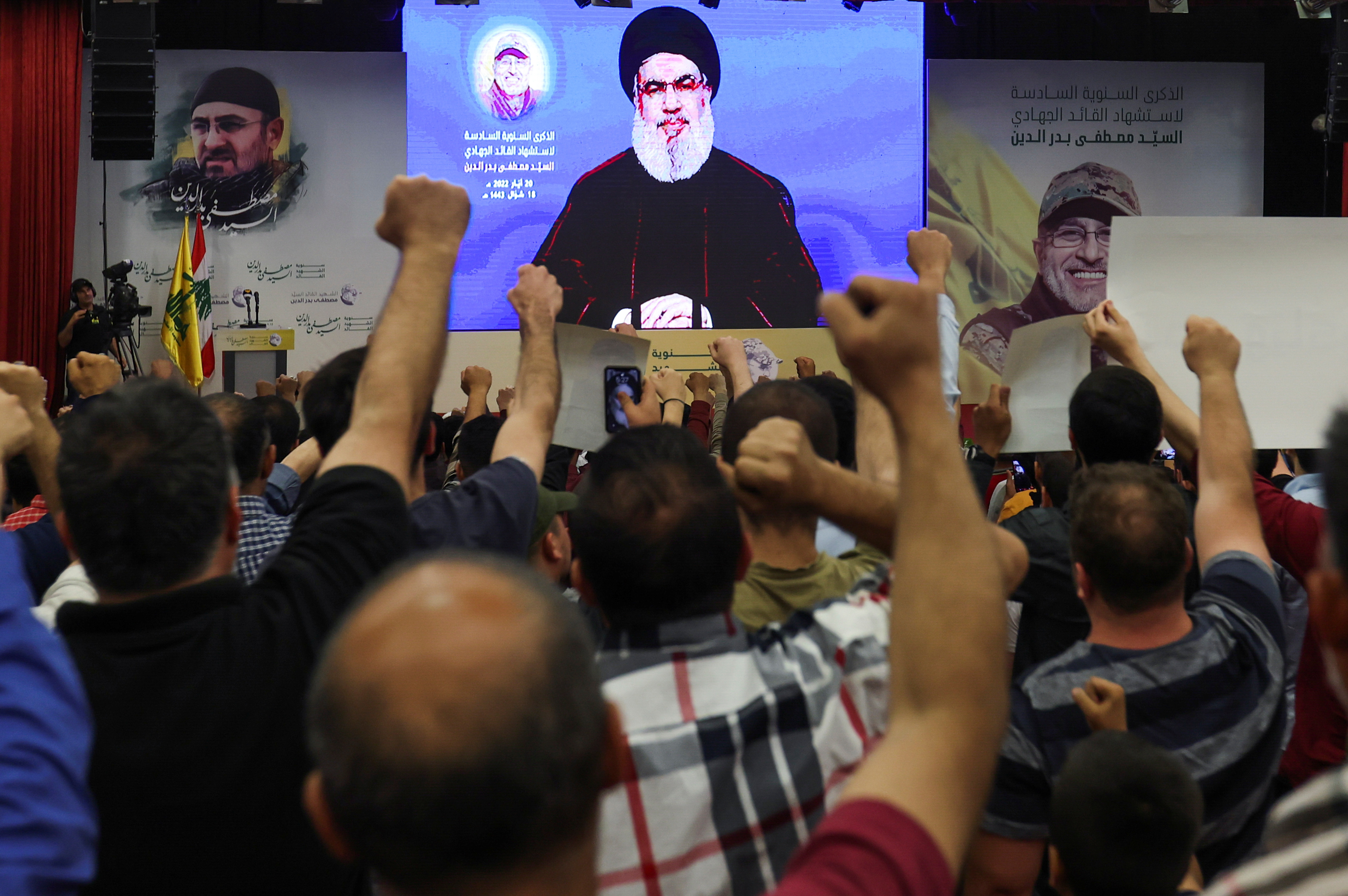 Lebanon's Hezbollah leader Sayyed Hassan Nasrallah addresses his supporters via a screen