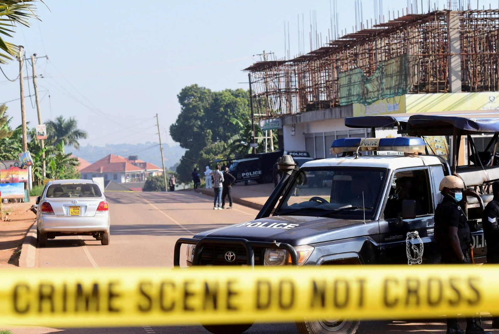 Ugandan police members secure the scene of an explosion in Komamboga, on the northern outskirts of Kampala