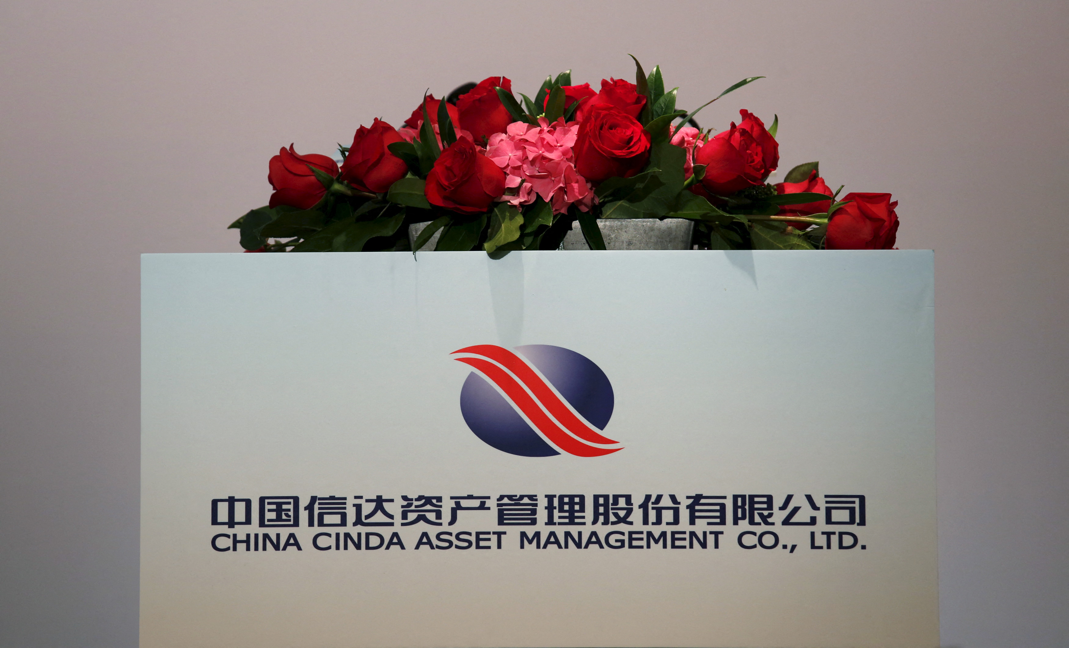 The company logo of China Cinda Asset Management Co Ltd is displayed at a news conference on the company's annual results in Hong Kong