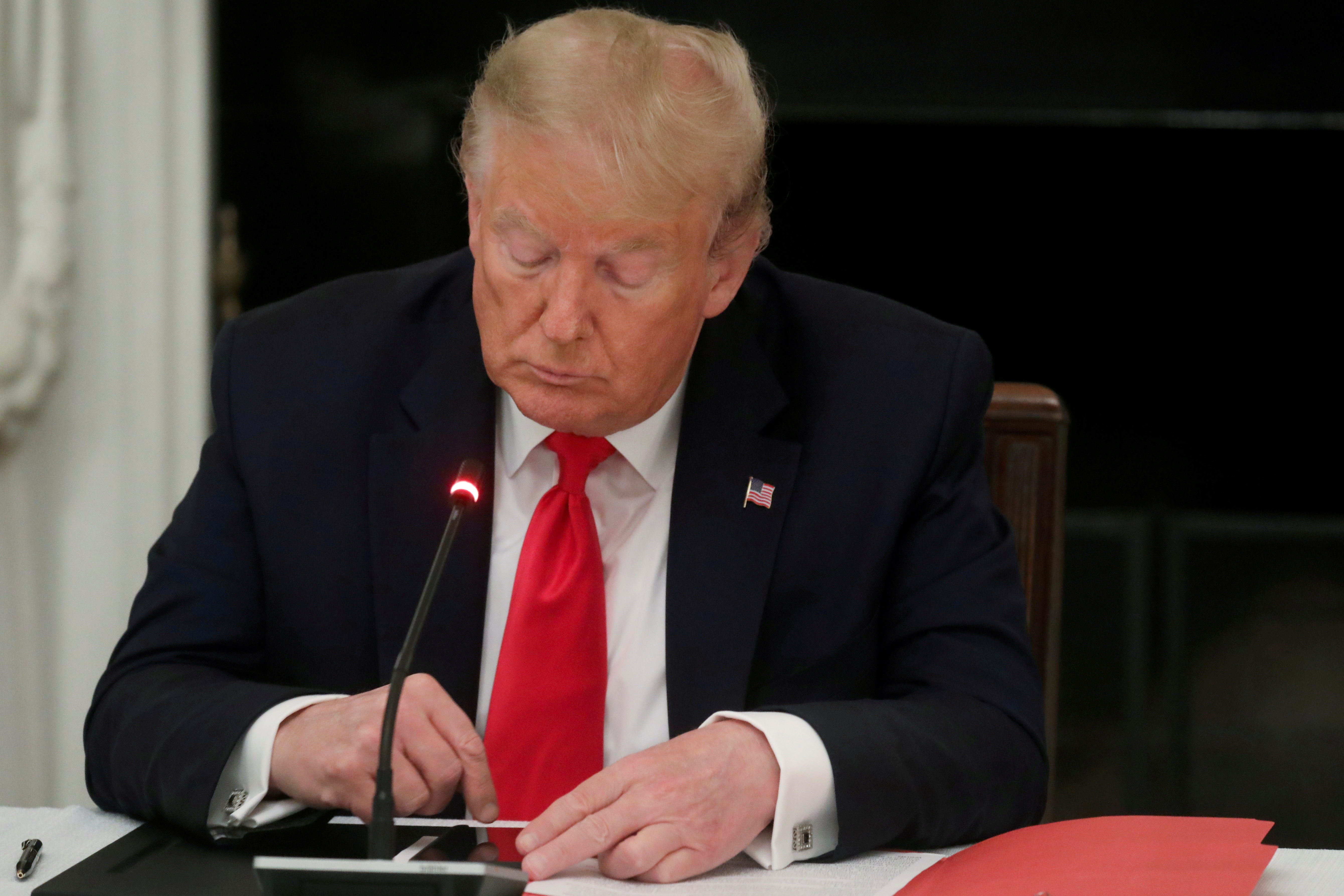 U.S. President Donald Trump is seen tapping the screen on a mobile phone at the White House in Washington, U.S., June 18, 2020. REUTERS/Leah Millis/File Photo