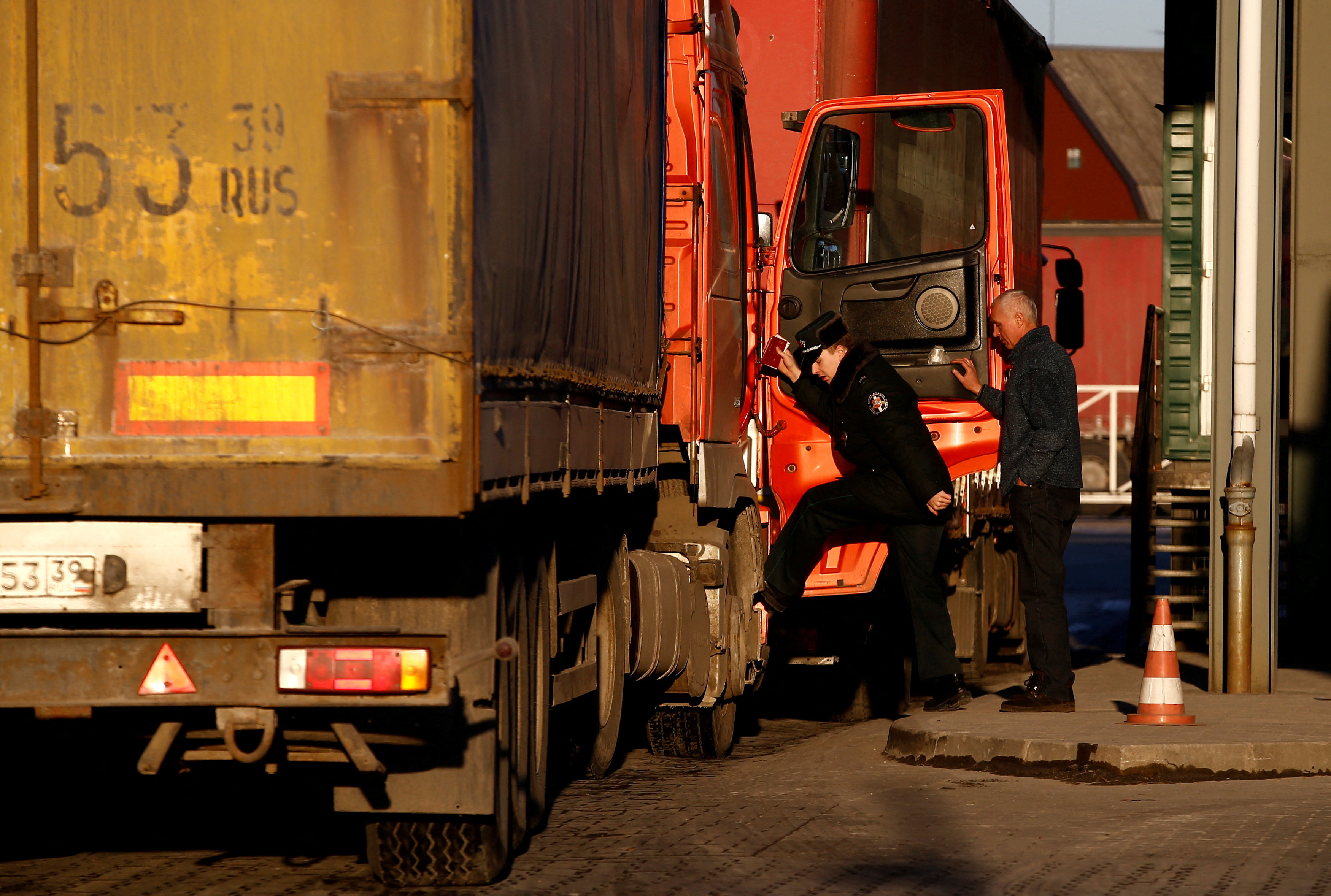 Border guard checks a truck at a border crossing point with Russia in Kybartai