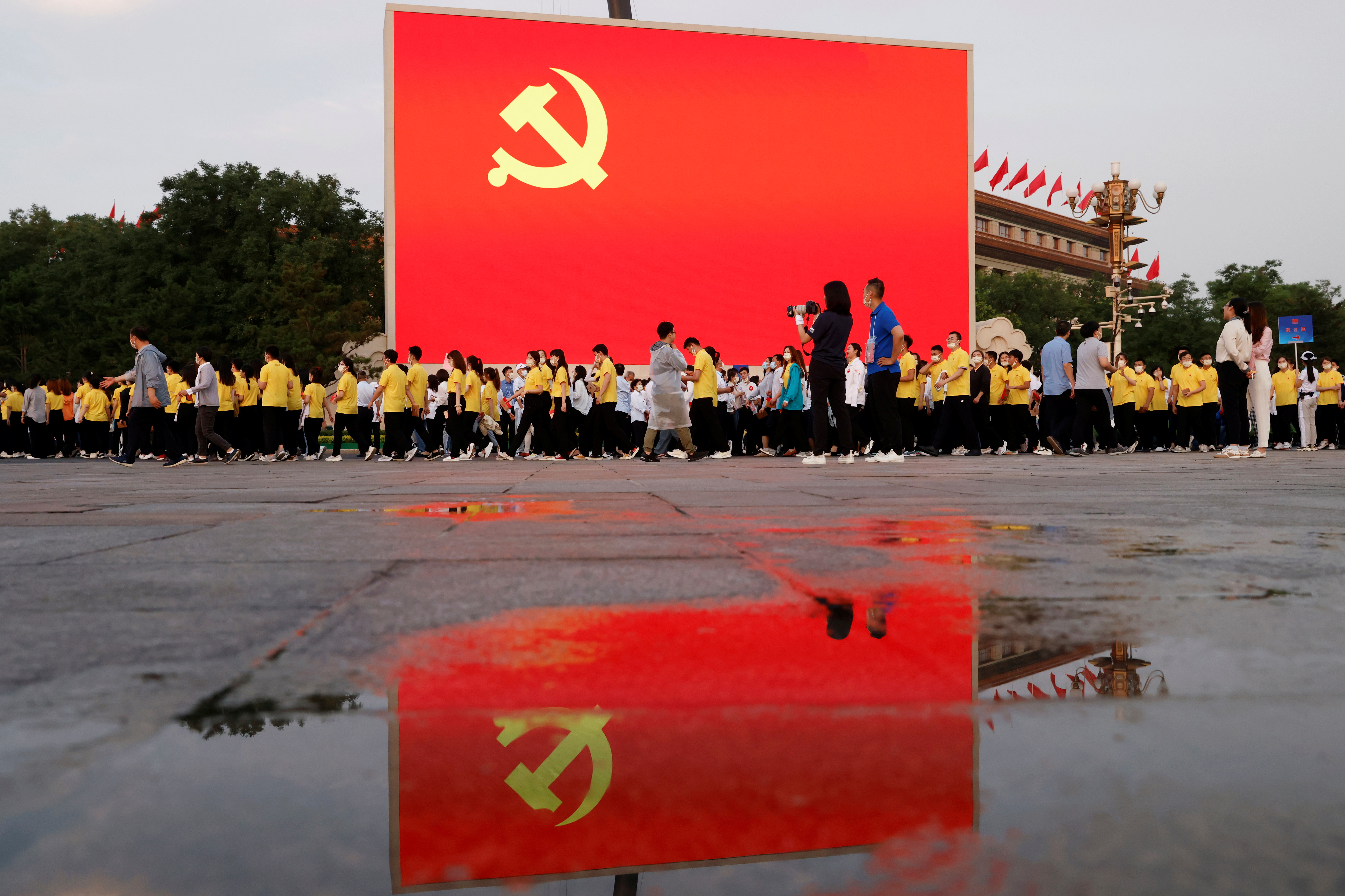 A screen shows an image of the Chinese Communist Party flag before the event marking the 100th founding anniversary of the Communist Party of China, on Tiananmen Square in Beijing, China, July 1, 2021. REUTERS/Carlos Garcia Rawlins