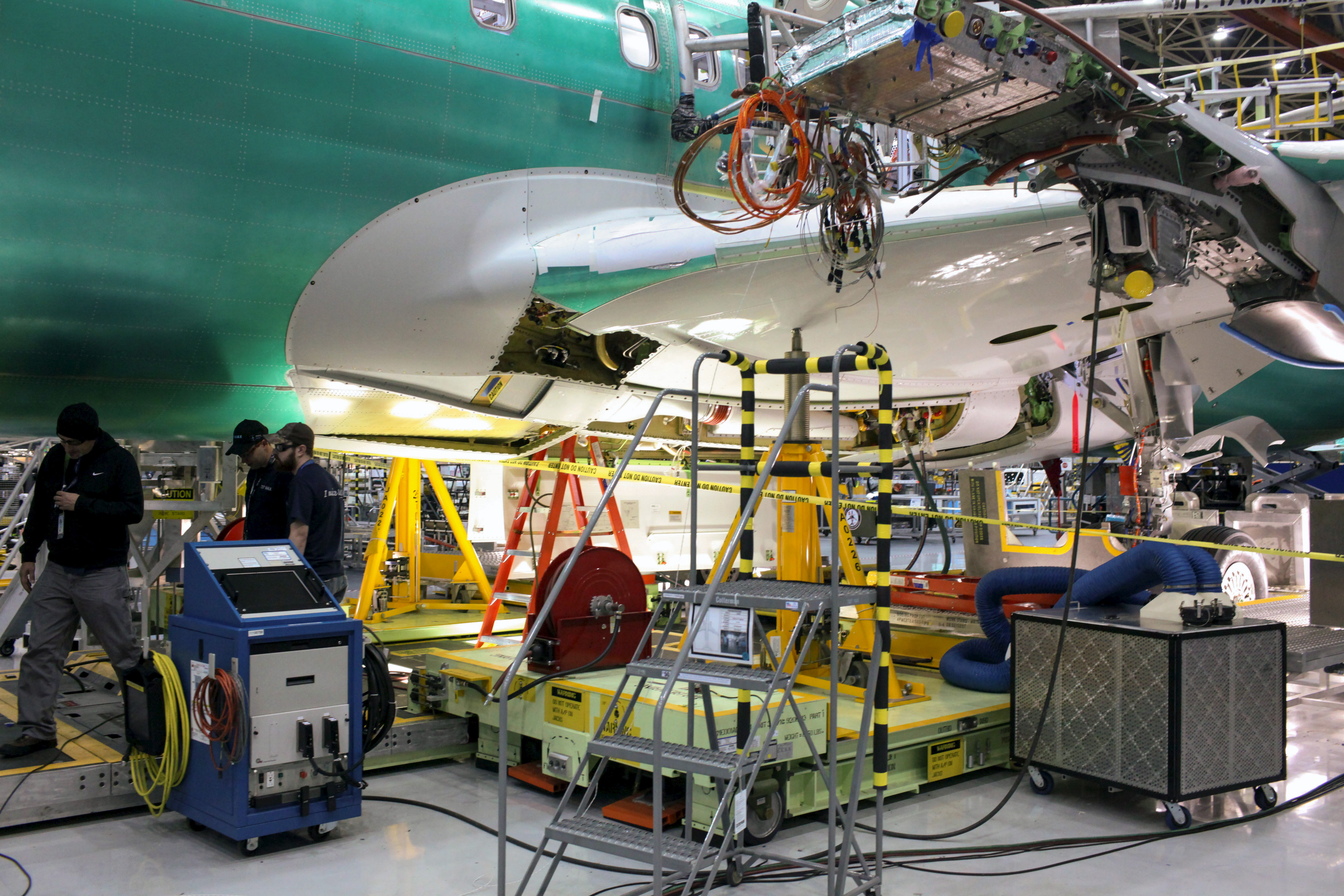 Boeing employees work during a media tour of the Boeing 737 MAX at the Boeing plant in Renton, Washington
