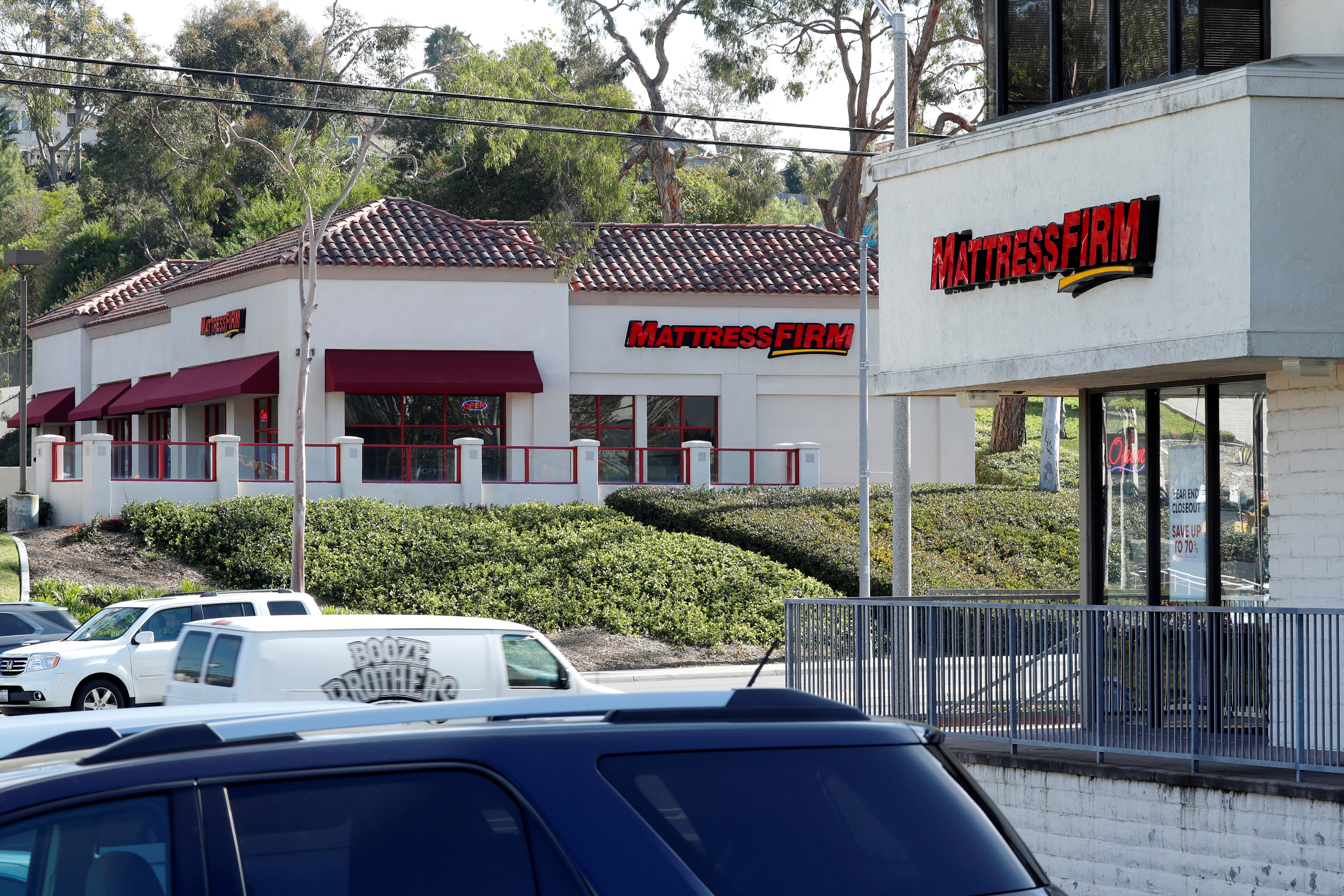 Two Mattress Firm stores are shown on either side of the street in Encinitas, California,