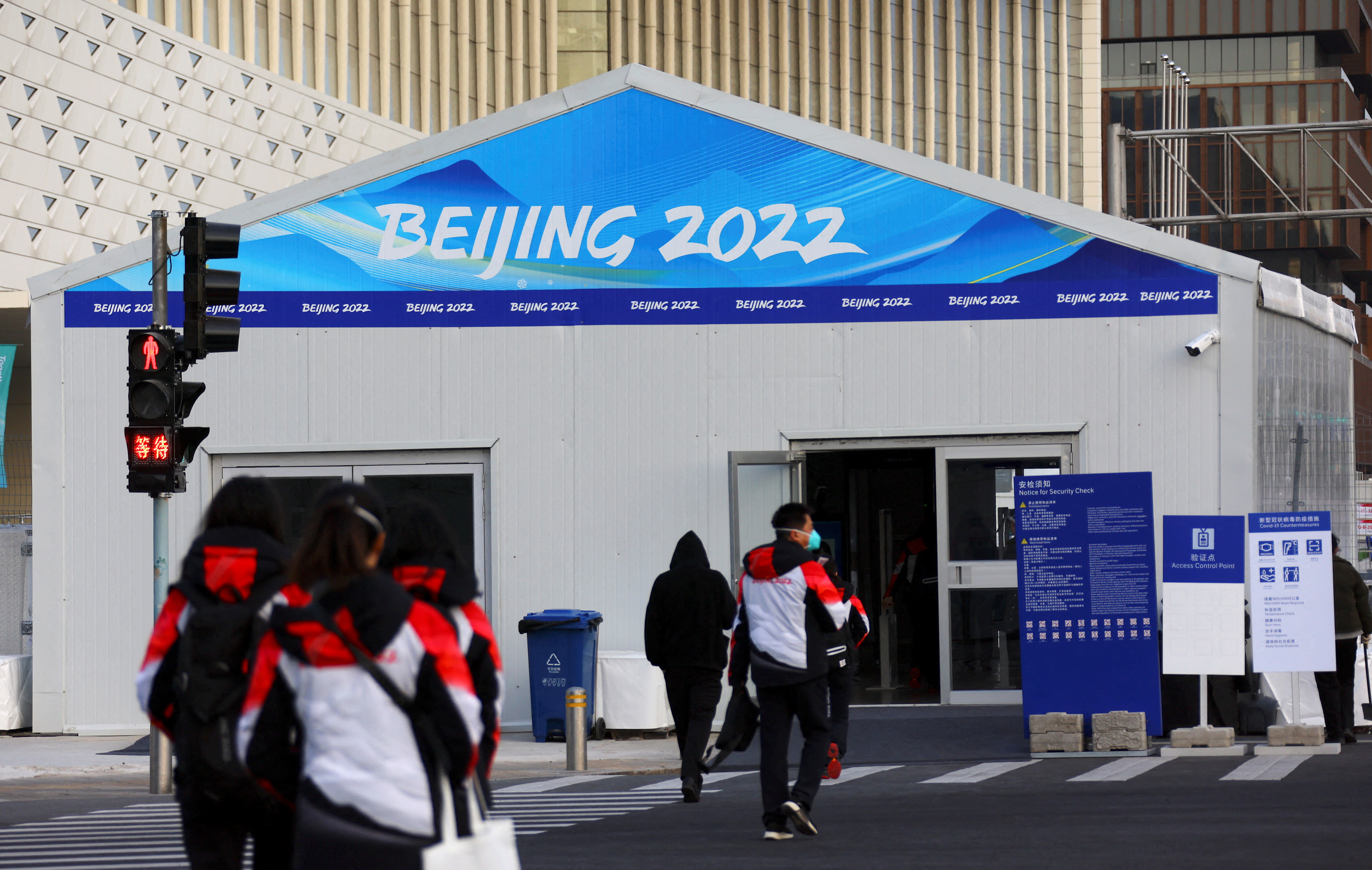 Volunteers walk outside the Main Press Centre ahead of the Beijing 2022 Winter Olympics in Beijing