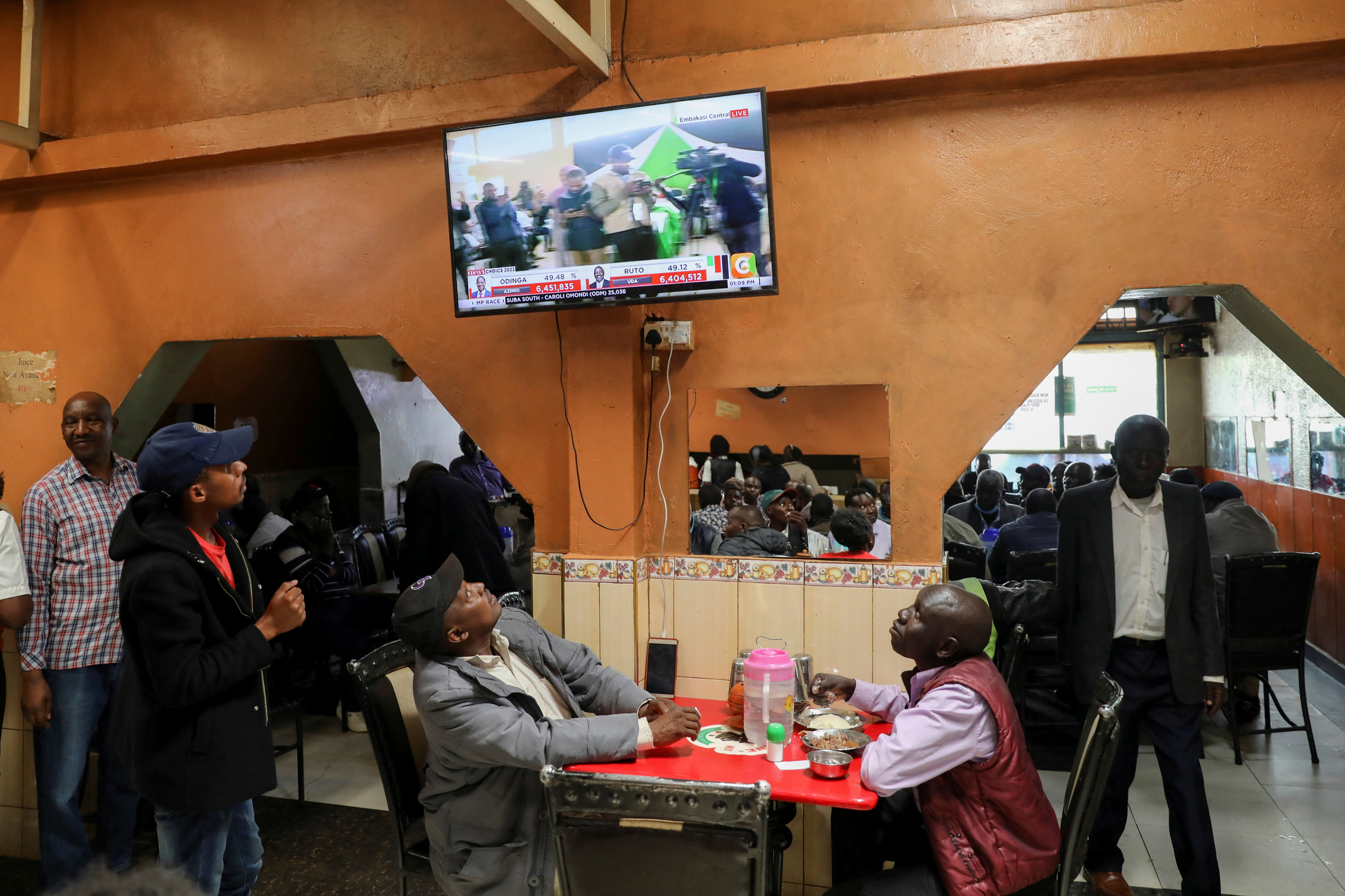 Kenyans watch a television for election results at the Silverline Butchery restaurant in Eldoret