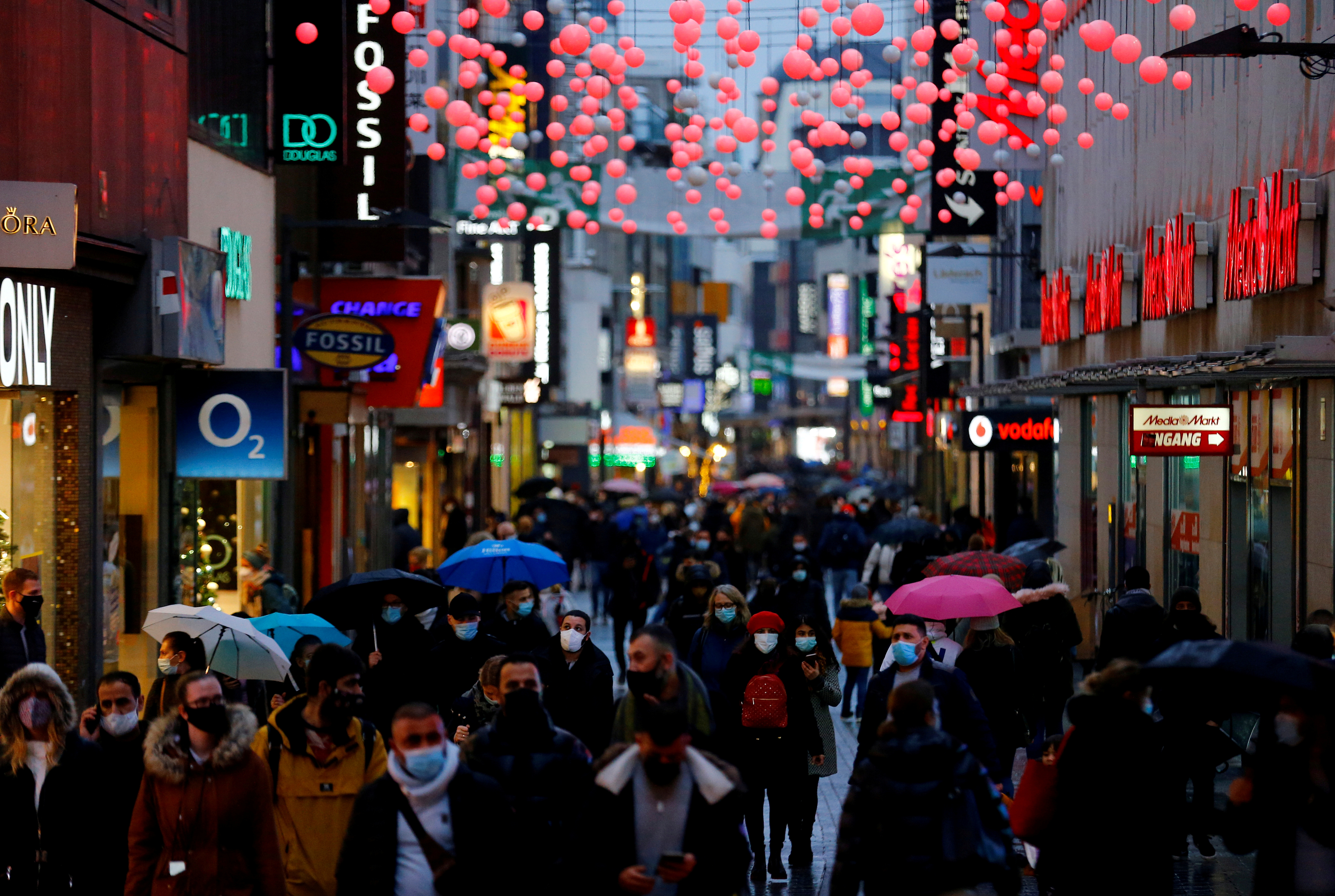 Shoppers walk down Hohe Strasse shopping district in Cologne, Germany, December 15, 2020. REUTERS/Thilo Schmuelgen