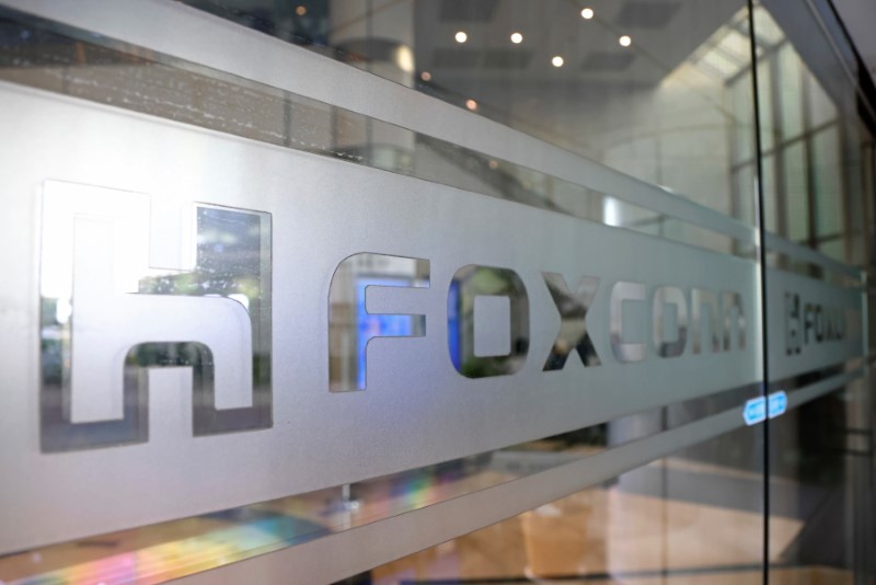 Sign of Foxconn is seen at a glass door inside its office building in Taipei