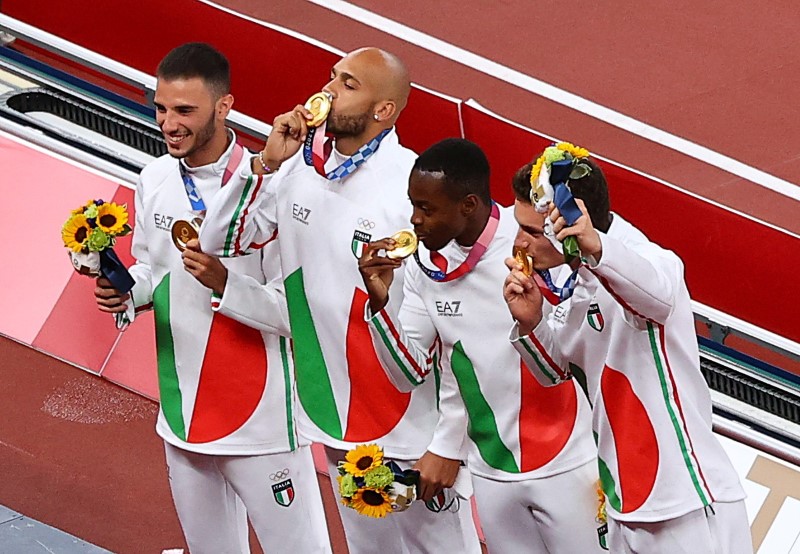 Tokyo 2020 Olympics - Athletics - Men's 4 x 400m Relay - Medal Ceremony - Olympic Stadium, Tokyo, Japan - August 7, 2021. Gold medallists Lorenzo Patta of Italy, Lamont Marcell Jacobs of Italy, Eseosa Desalu of Italy and Filippo Tortu of Italy celebrate on the podium REUTERS/Fabrizio Bensch