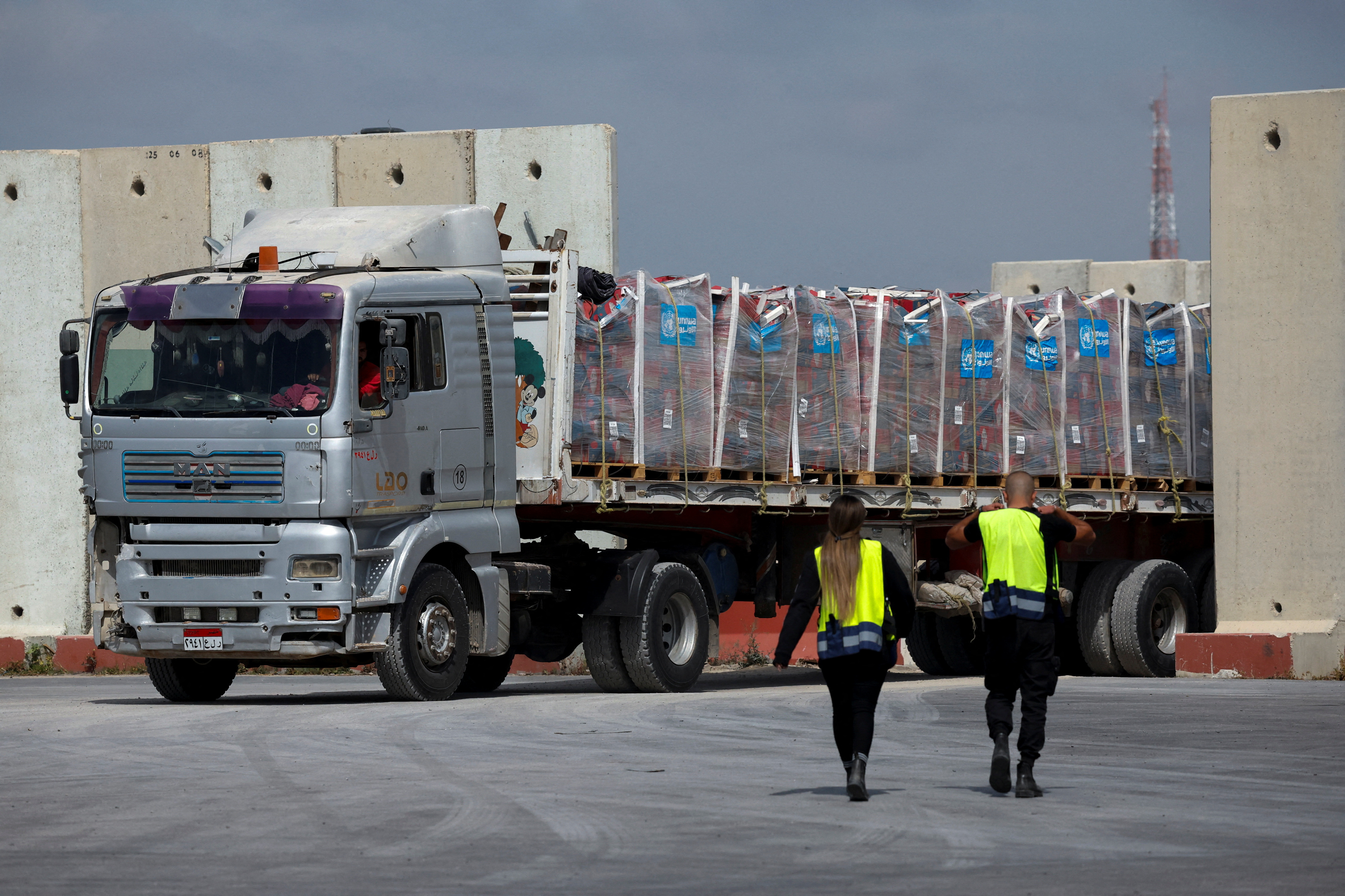 A truck carrying humanitarian aid bound for the Gaza Strip drives at the inspection area at the Kerem Shalom crossing
