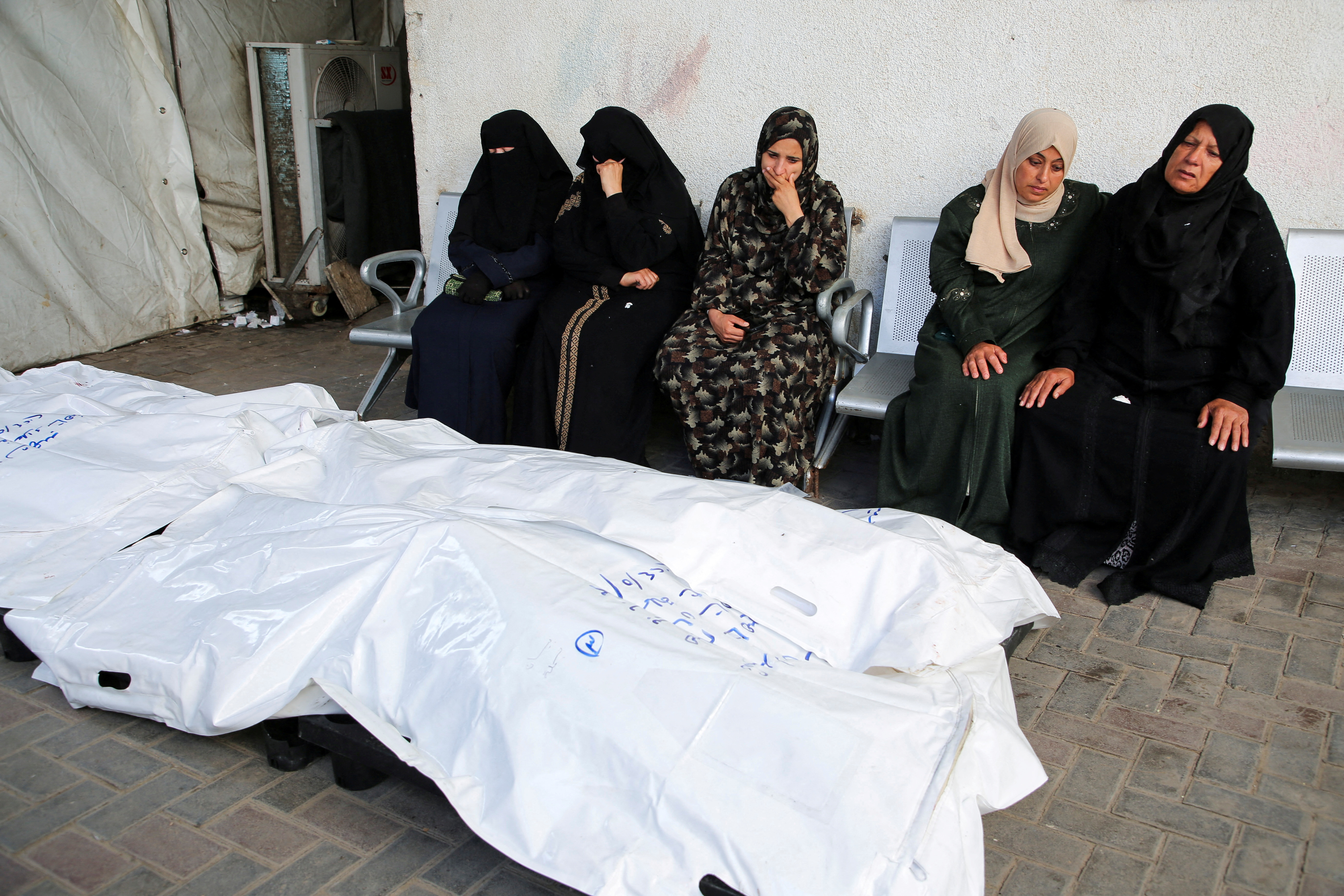 Mourners react next to the bodies of Palestinians killed in an Israeli strike, in Rafah, southern Gaza Strip
