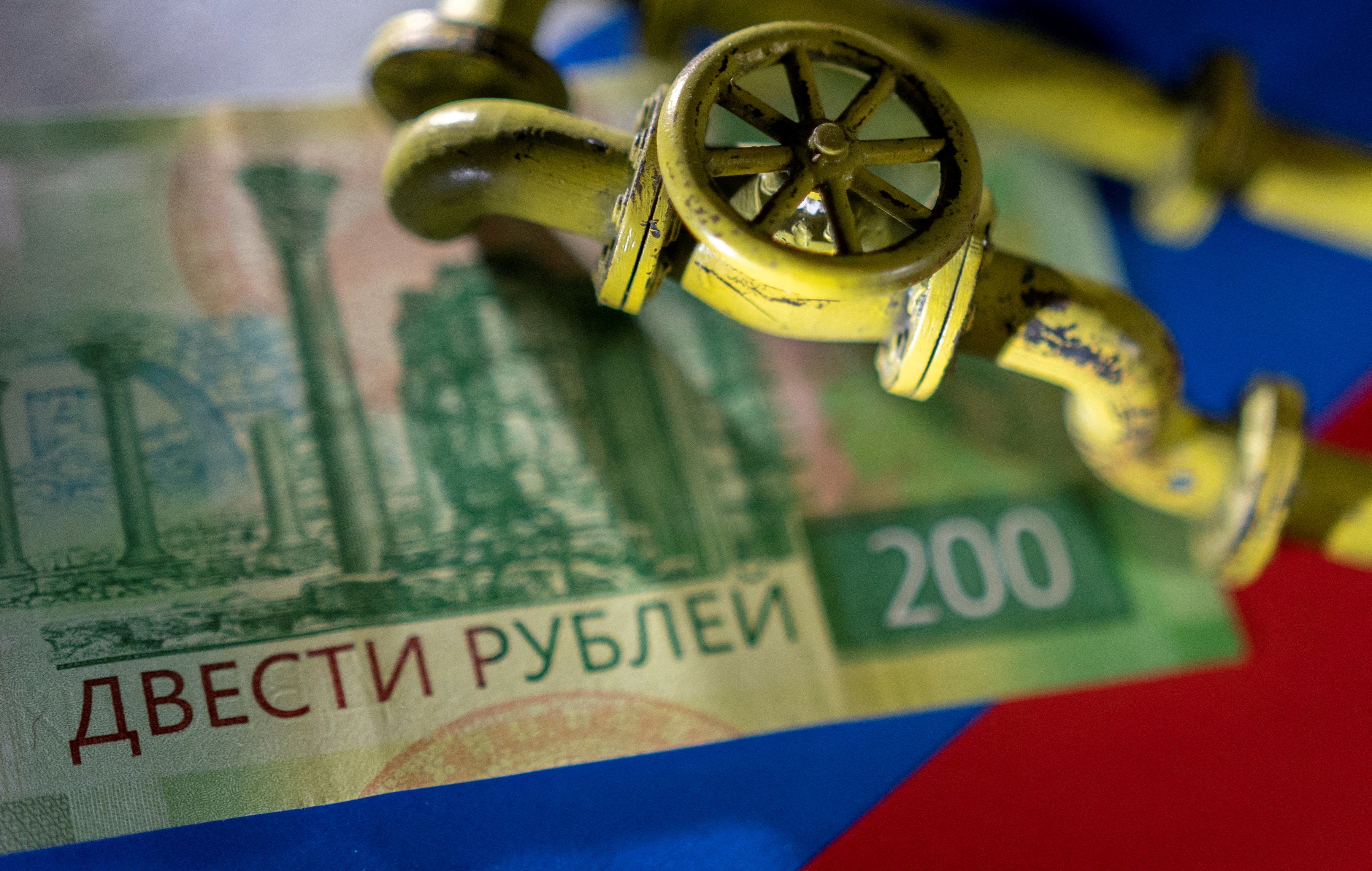 llustration shows natural gas pipeline, Russian rouble banknote and flag
