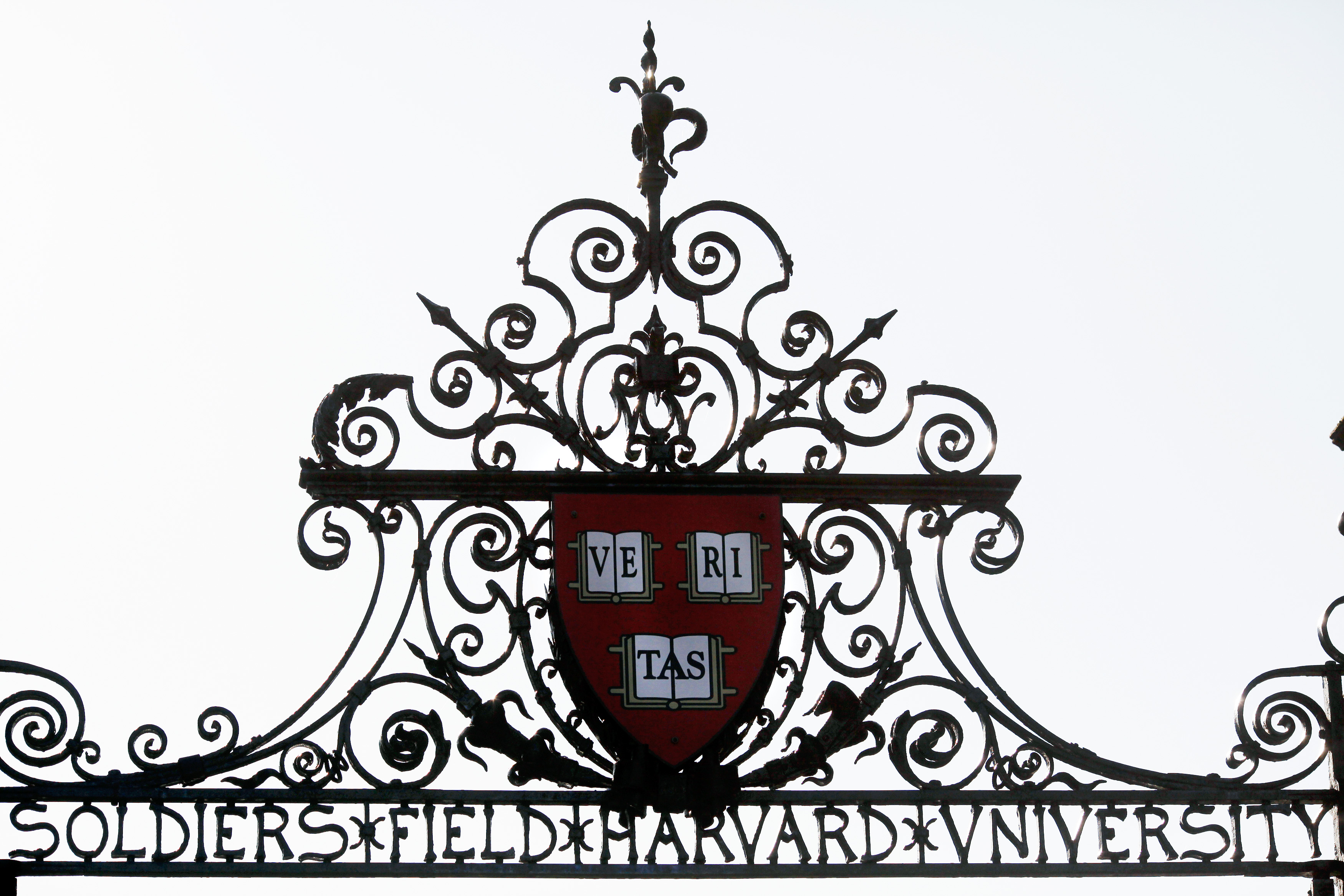 Harvard's seal sits atop a gate to the athletic fields at Harvard University in Cambridge