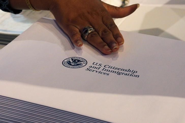 Information packs are distributed by the U.S. Citizenship and Immigration Services following a citizenship ceremony at the John F. Kennedy Presidential Library in Boston