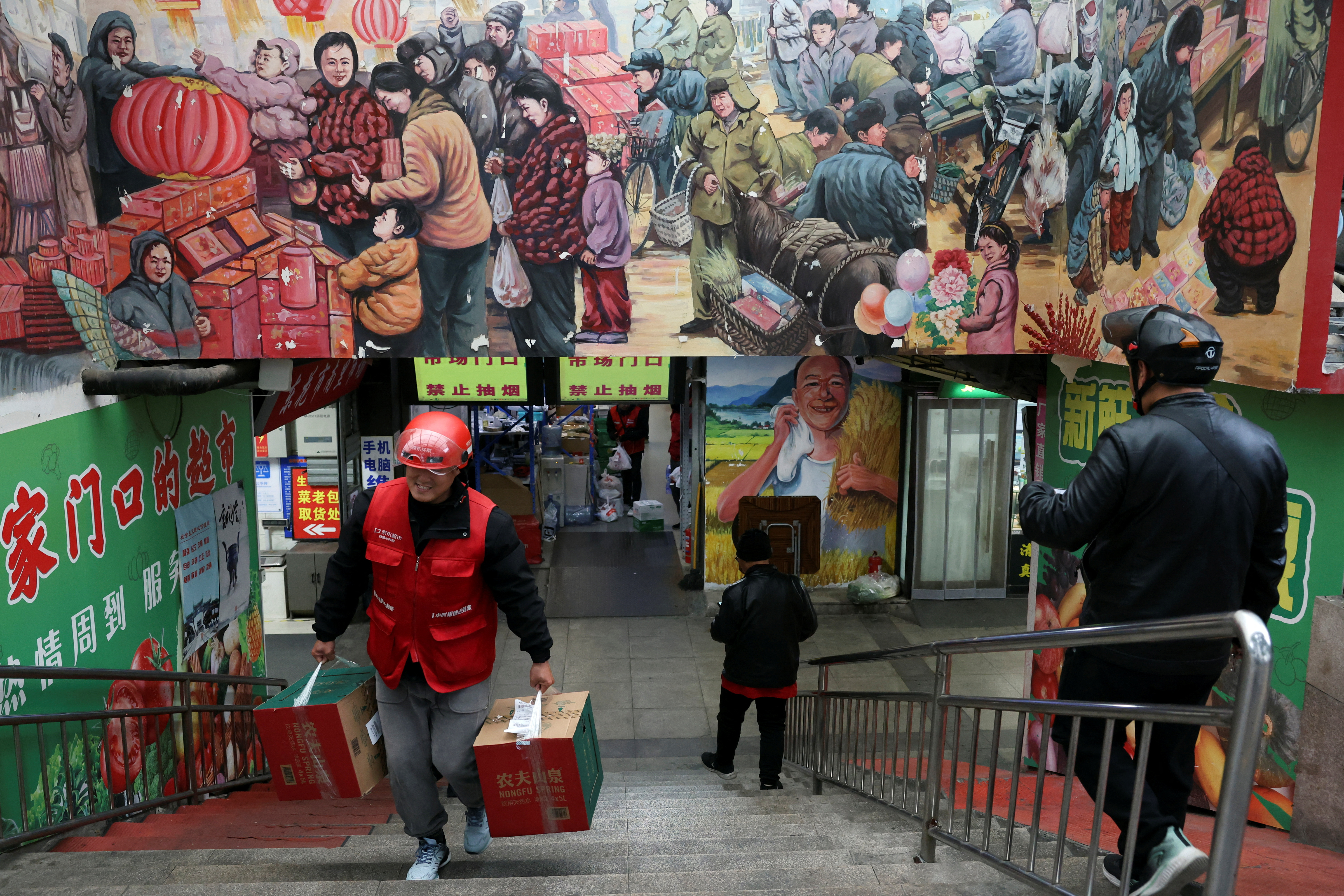 Delivery worker picks up grocery orders from a market in Beijing