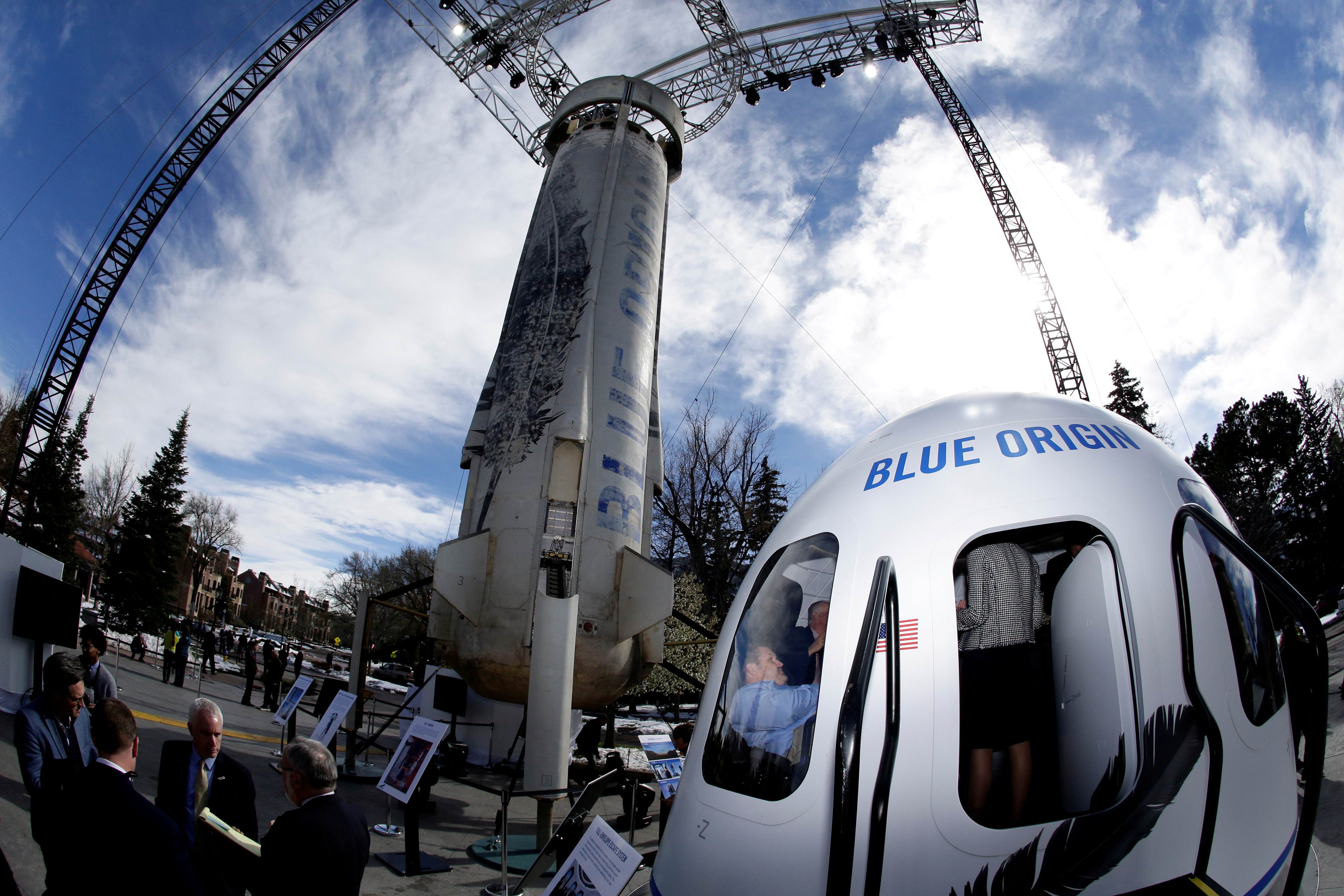 Members of the media tour the Blue Origin Crew Capsule mockup and New Shepard rocket booster at the 33rd Space Symposium in Colorado Springs, Colorado