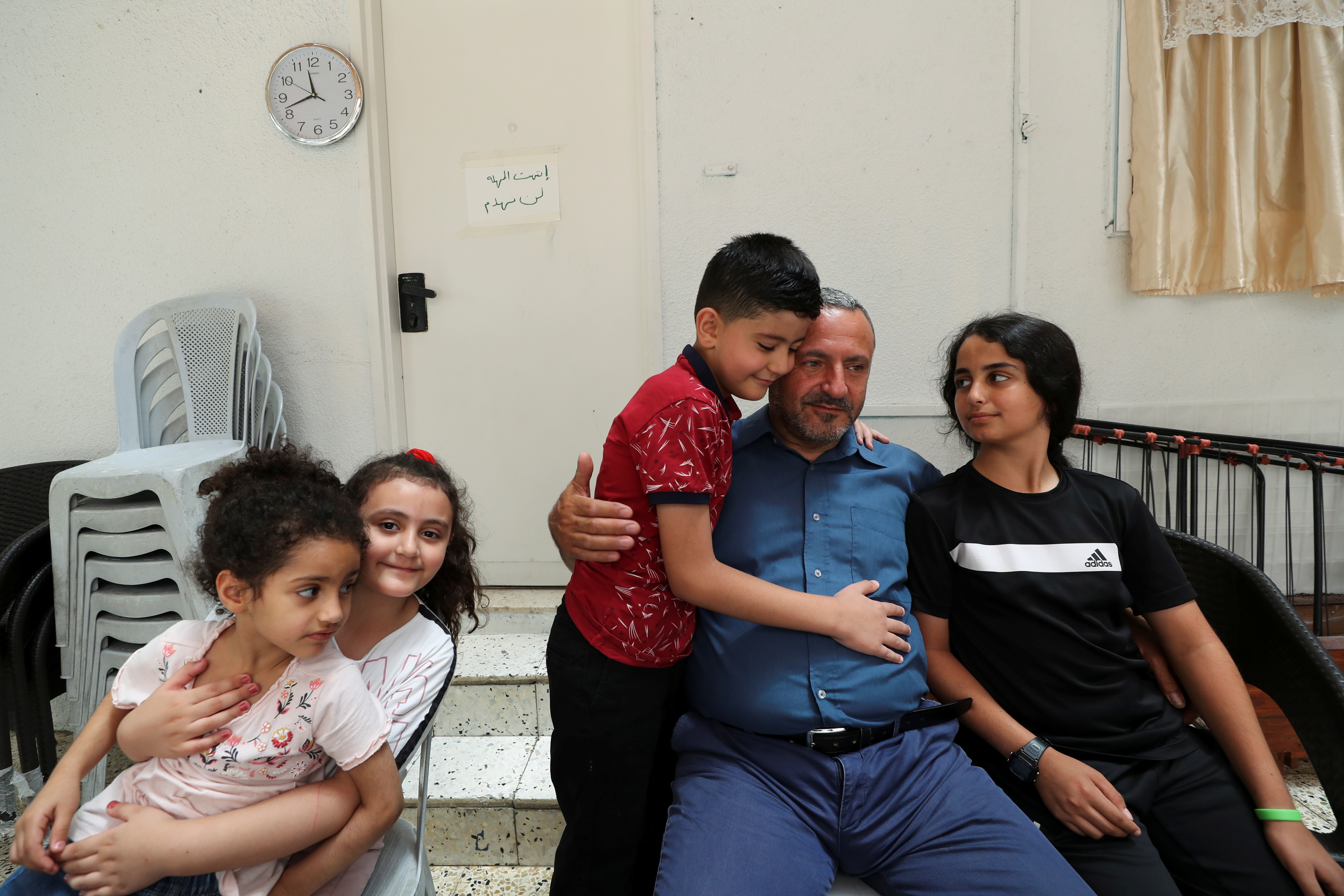 Palestinian resident Nader Abu Diab and his children are seen at their home in Silwan neighbourhood of East Jerusalem