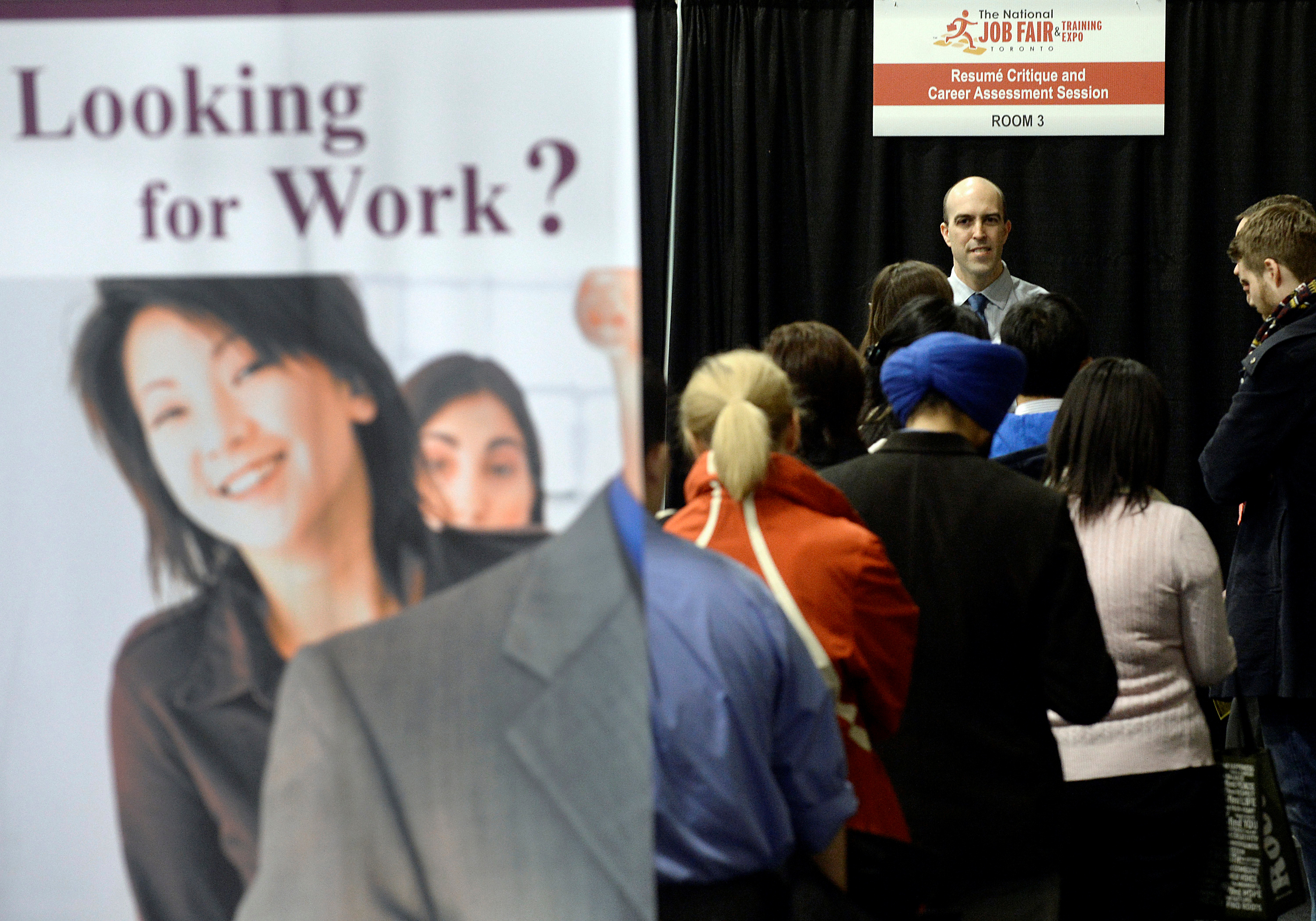 People wait in line for resume critique and career assessment sessions at 2014 Spring National Job Fair and Training Expo in Toronto