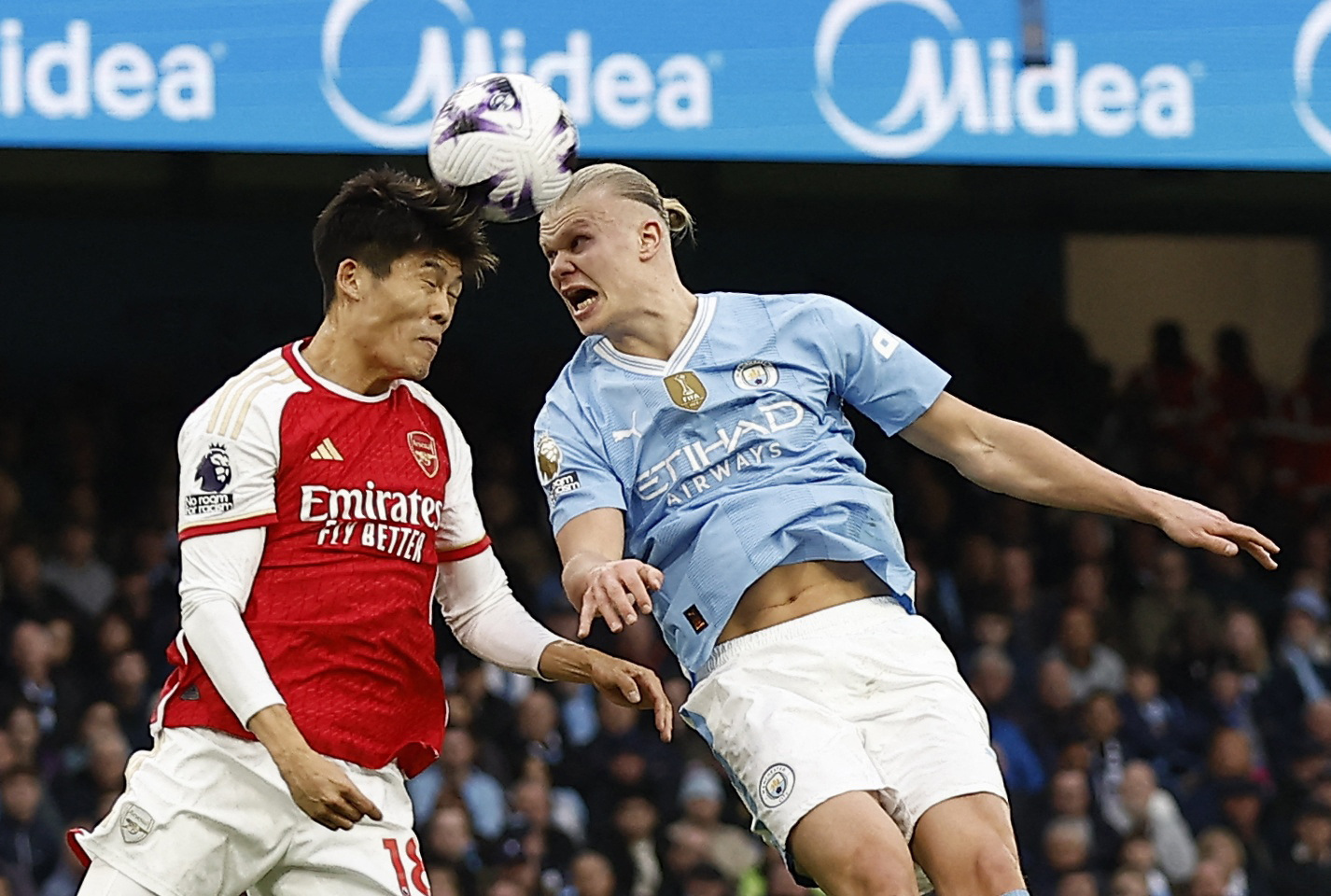 Soccer Football - Premier League - Manchester City v Arsenal - Etihad Stadium, Manchester, Britain - March 31, 2024 Arsenal's Takehiro Tomiyasu in action with Manchester City's Erling Braut Haaland Action Images via Reuters/Jason Cairnduff 