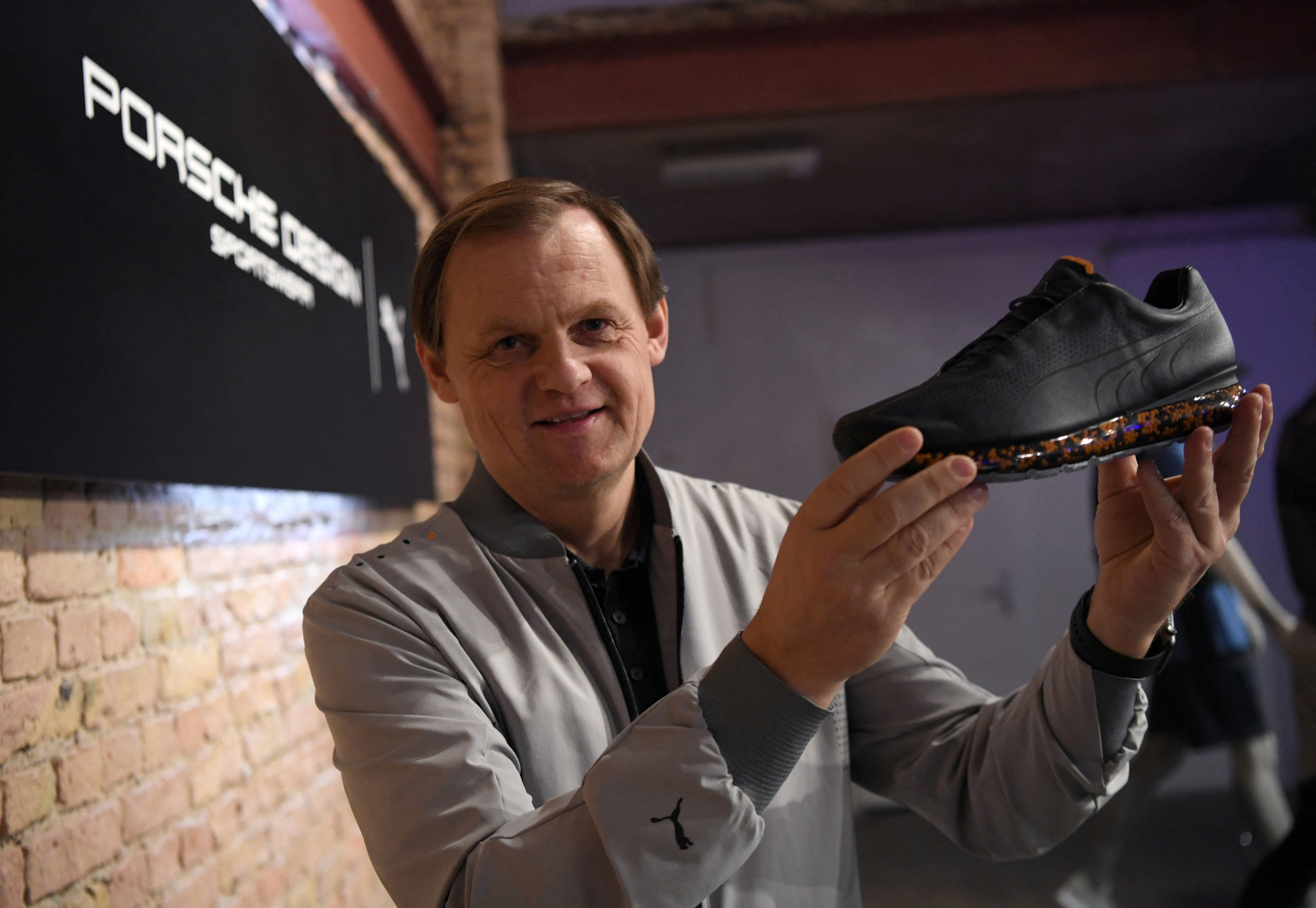 Puma CEO Gulden displays shoe at collection launch in collaboration with Porsche Design in Berlin