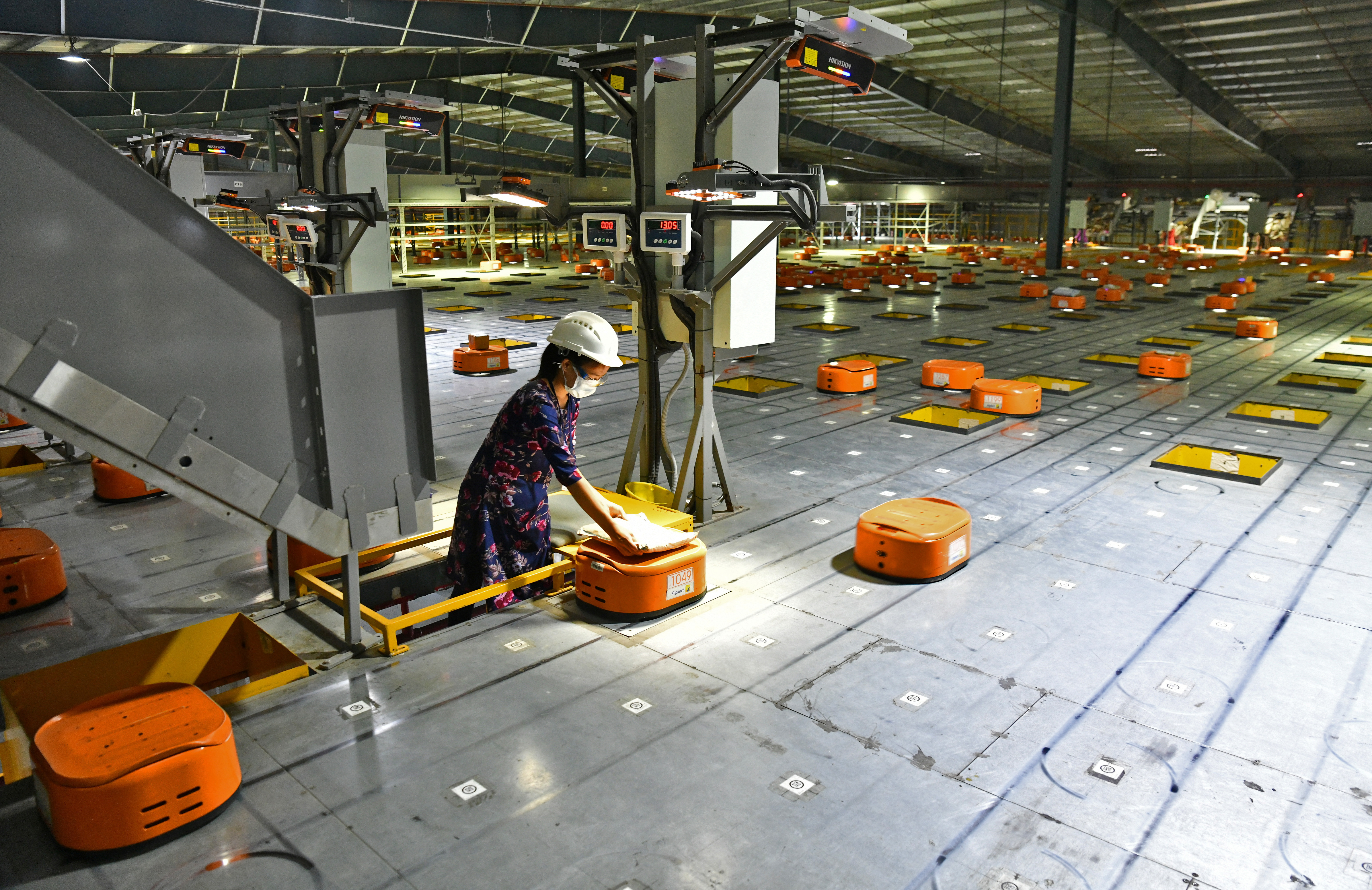 Worker uses AGV's at Flipkart, a leading e-commerce firm in India, to sort items inside its fulfilment centre on the outskirts of Bengaluru