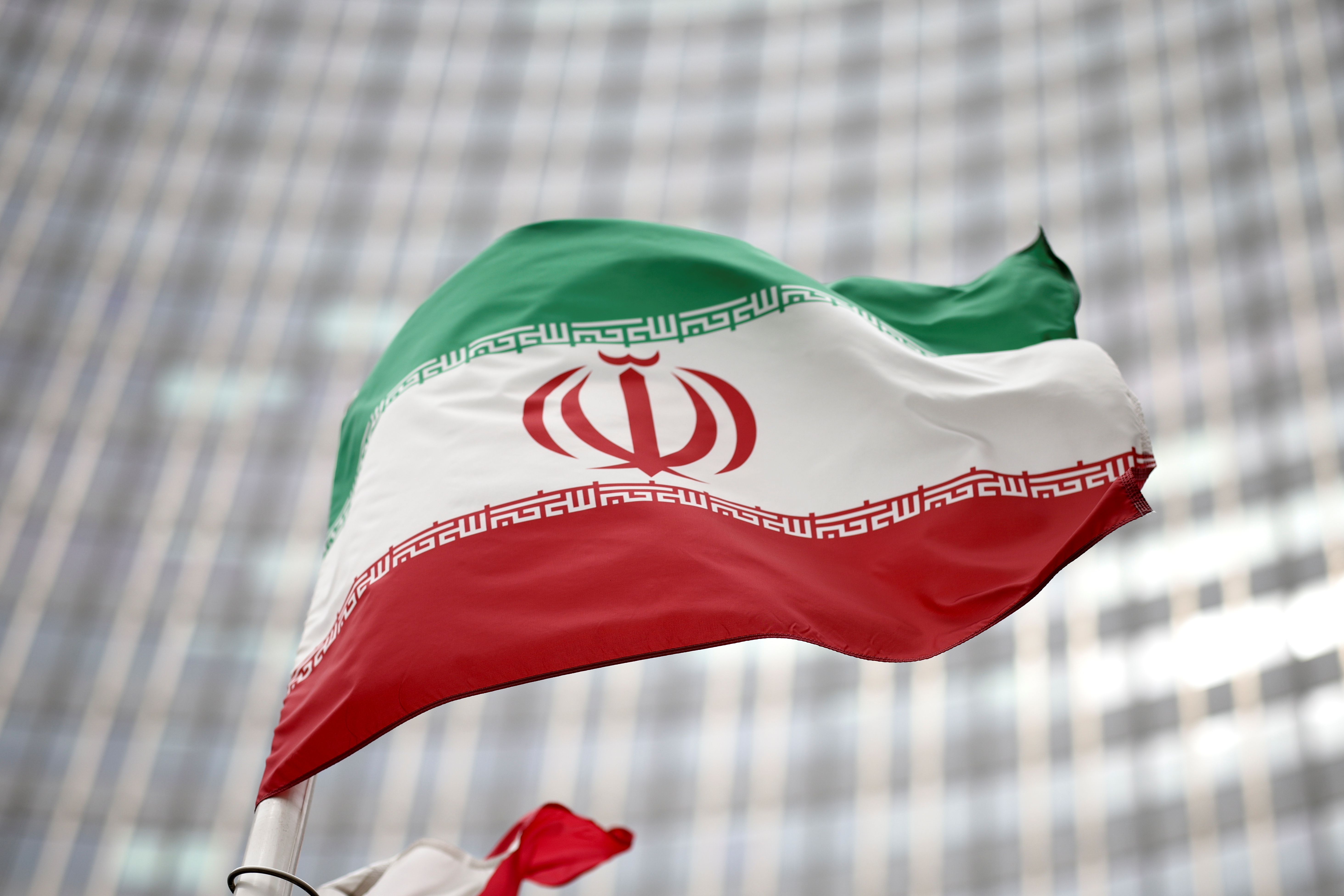 Iranian flag flies in front of the UN office building in Vienna