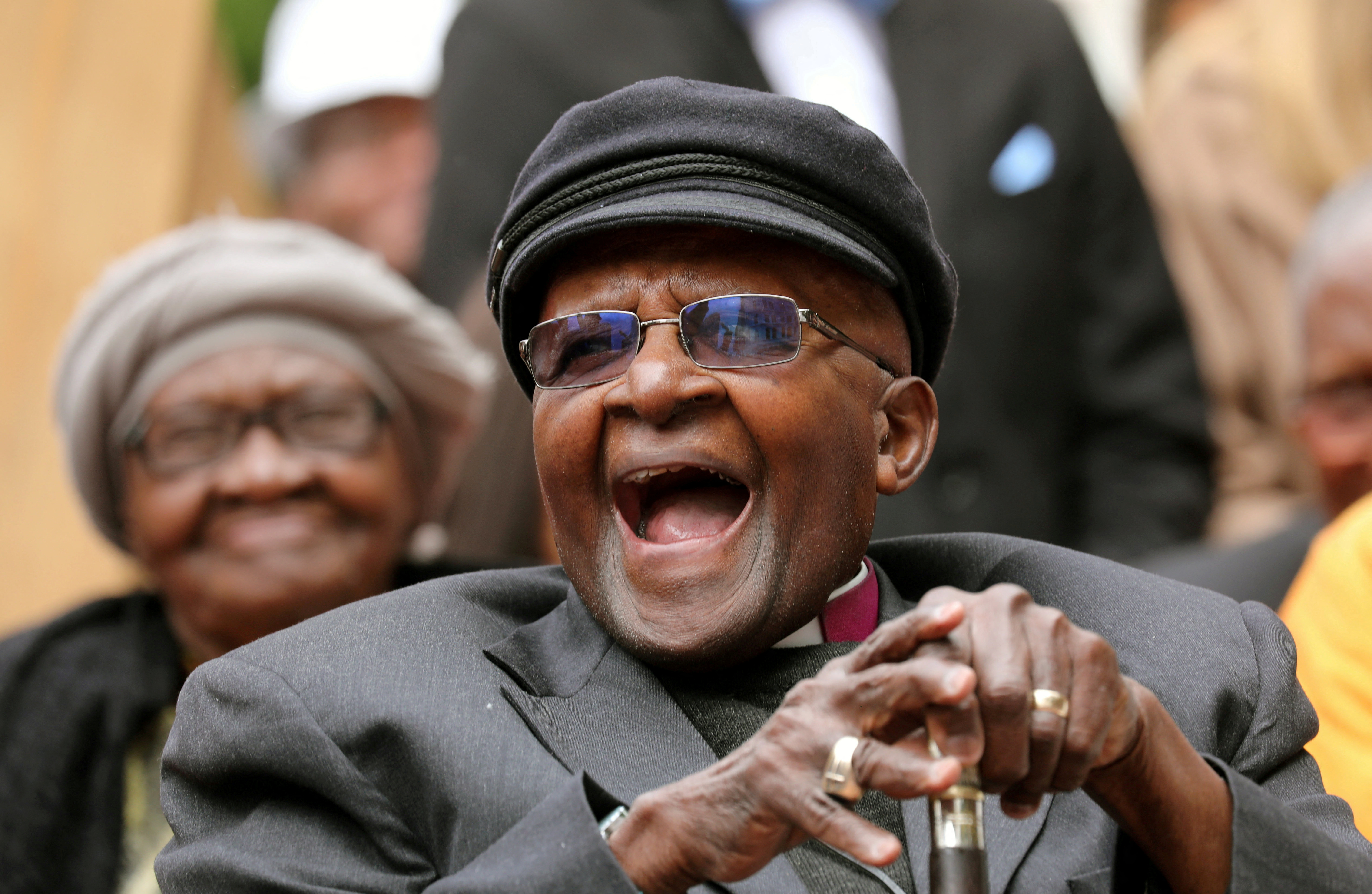 Archbishop Desmond Tutu laughs as crowds gather to celebrate his birthday by unveiling an arch in his honour outside St George's Cathedral in Cape Town, South Africa, October 7, 2017. REUTERS/Mike Hutchings    