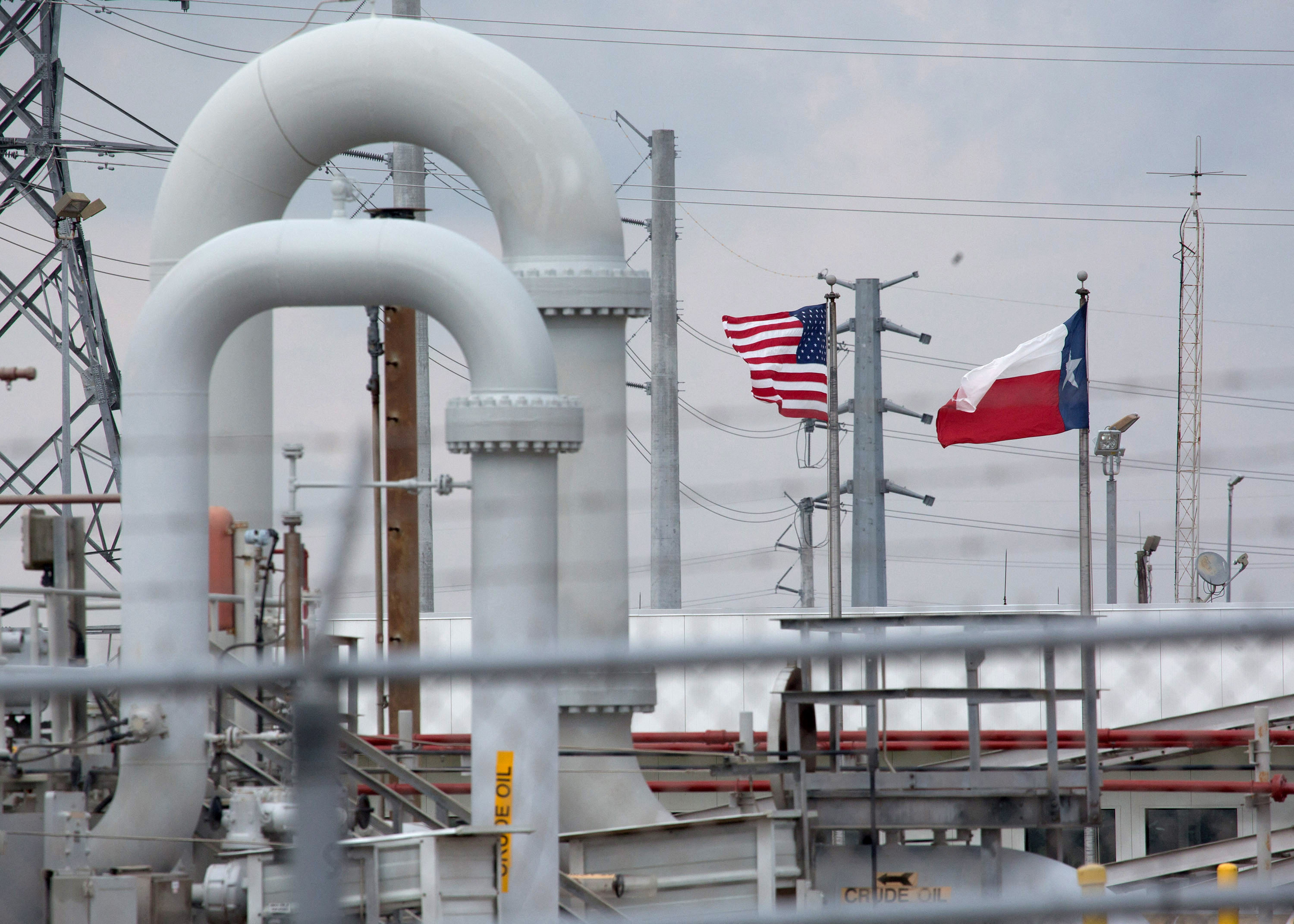 A maze of crude oil pipe and equipment is seen with the American and Texas flags flying during a tour by the Department of Energy at the Strategic Petroleum Reserve in Freeport