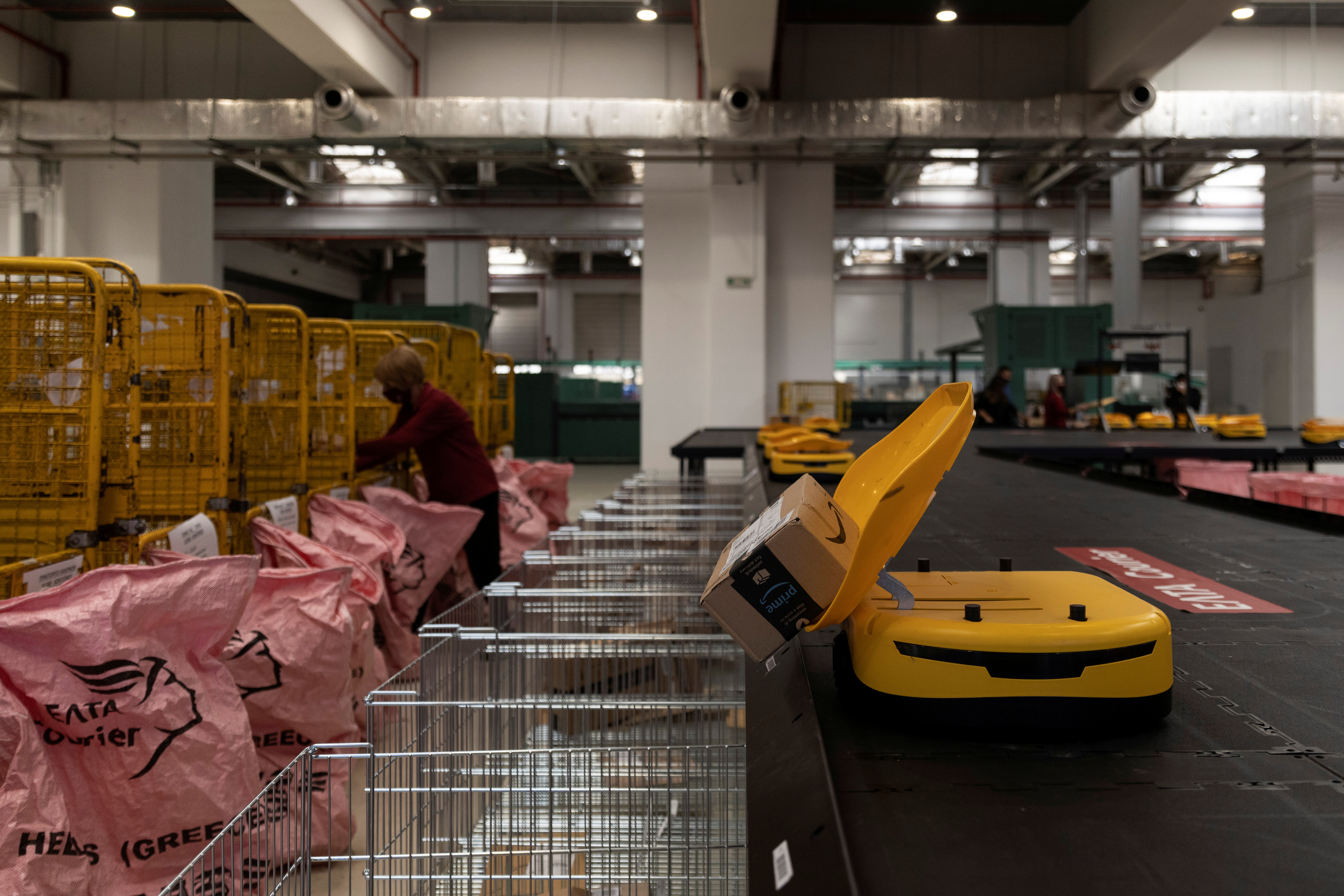 A robot drops a parcel in a mail sack at the Hellenic Post's sorting centre in Kryoneri