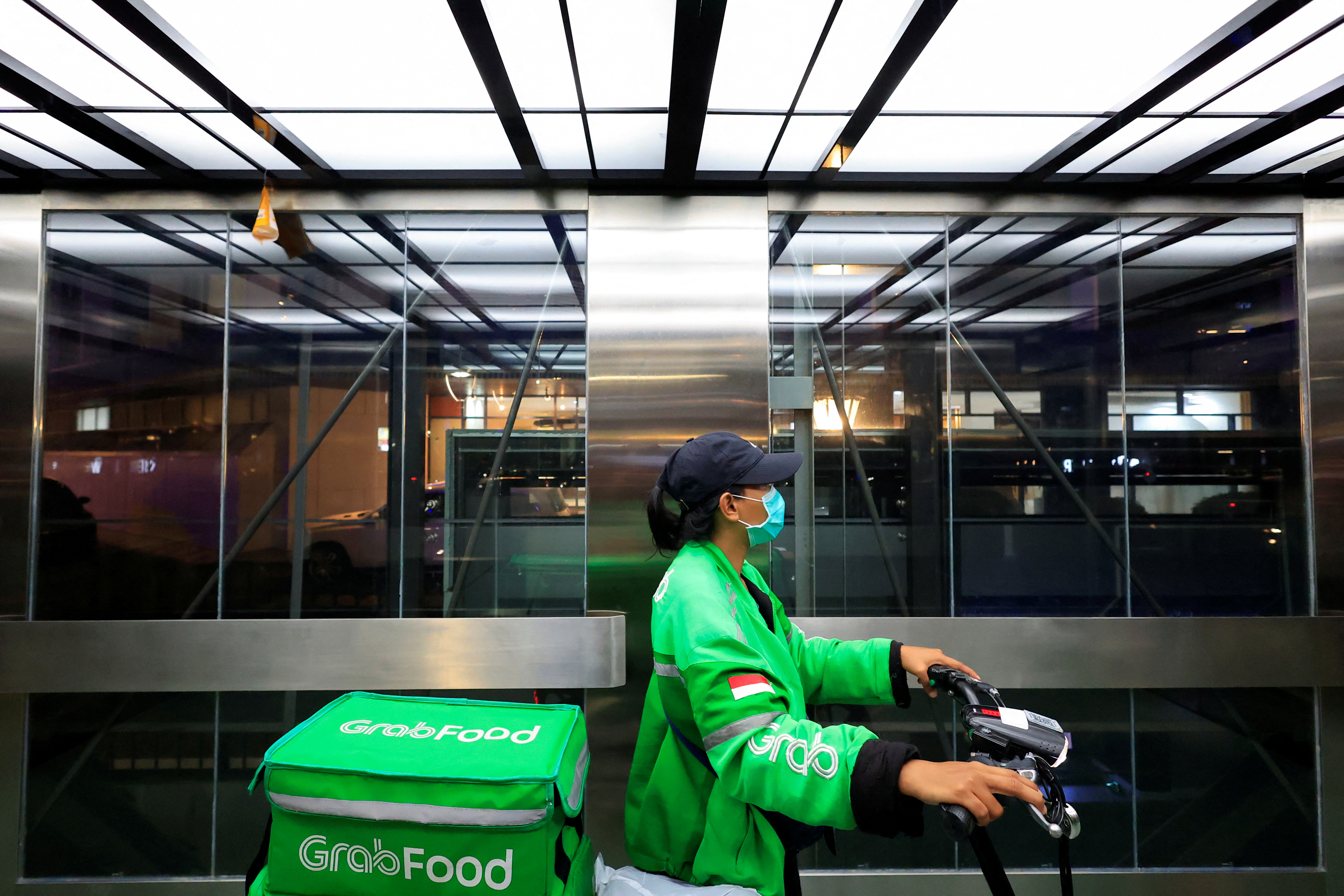 Driver working for the ridesharing company Grab delivers food amid of the COVID-19 pandemic in Jakarta