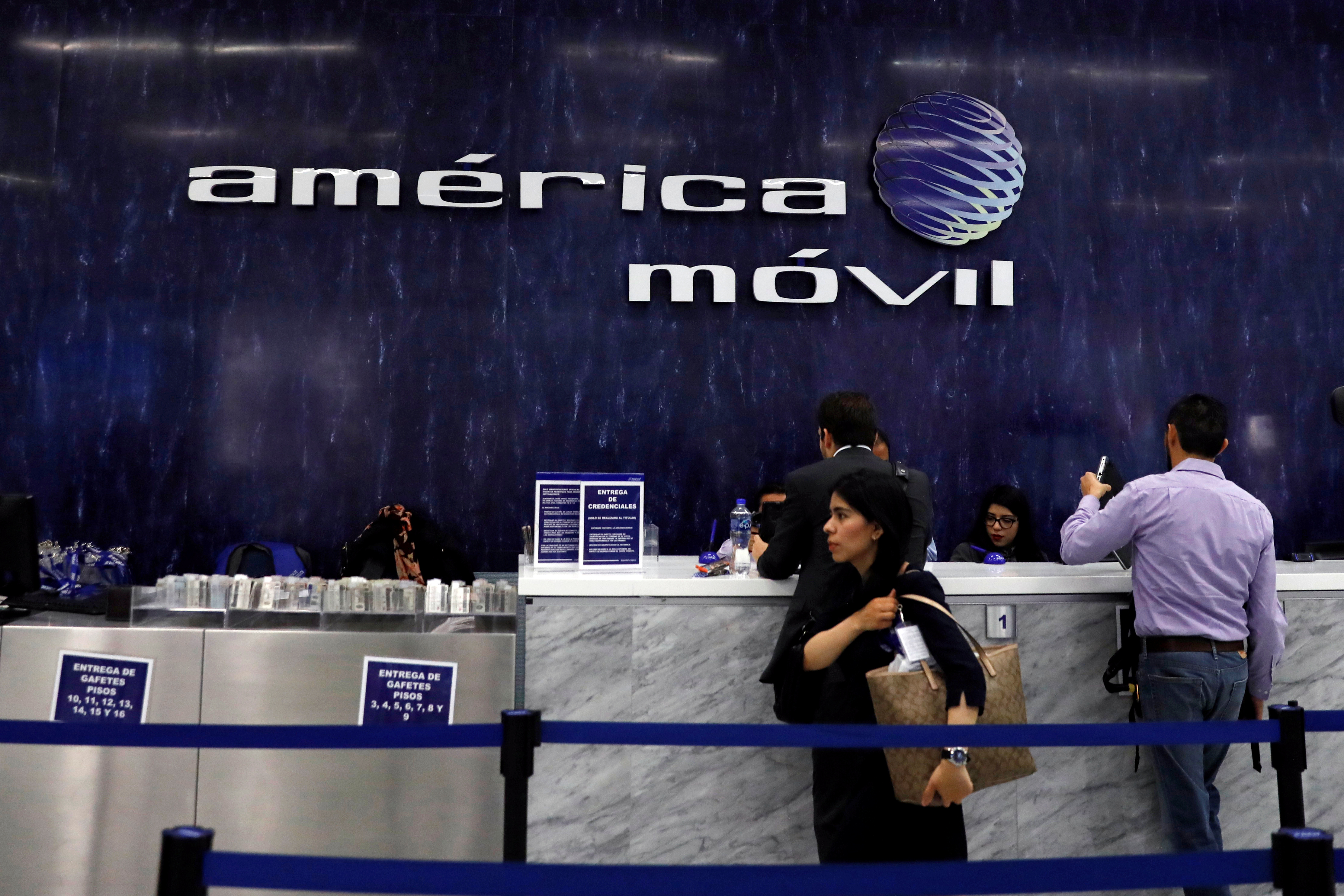 The logo of America Movill is seen on the wall at the company's corporate offices in Mexico City