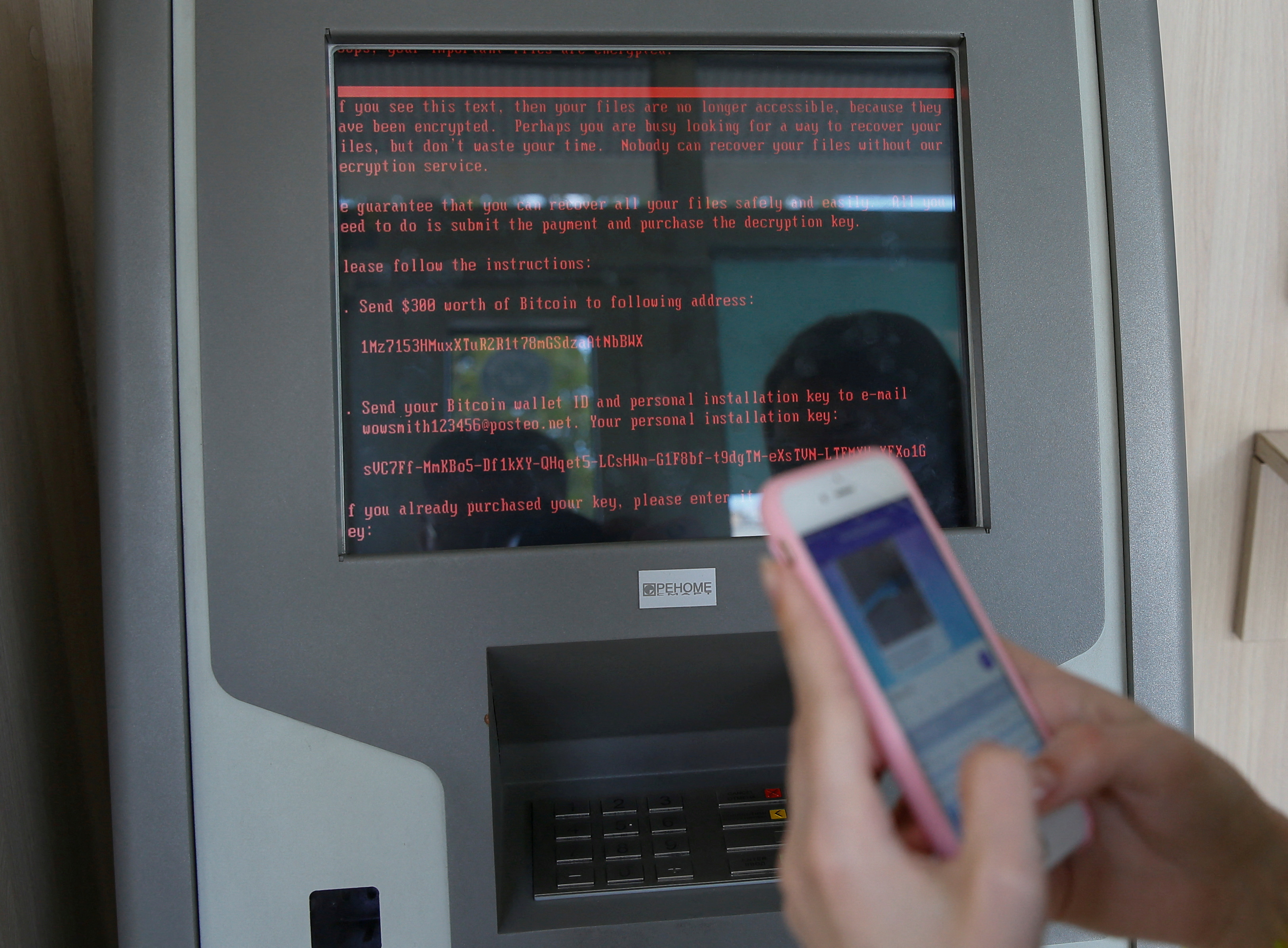 A message demanding money is seen on a monitor of a payment terminal at a branch of Ukraine's state-owned bank Oschadbank after Ukrainian institutions were hit by a wave of cyber attacks earlier in the day, in Kiev