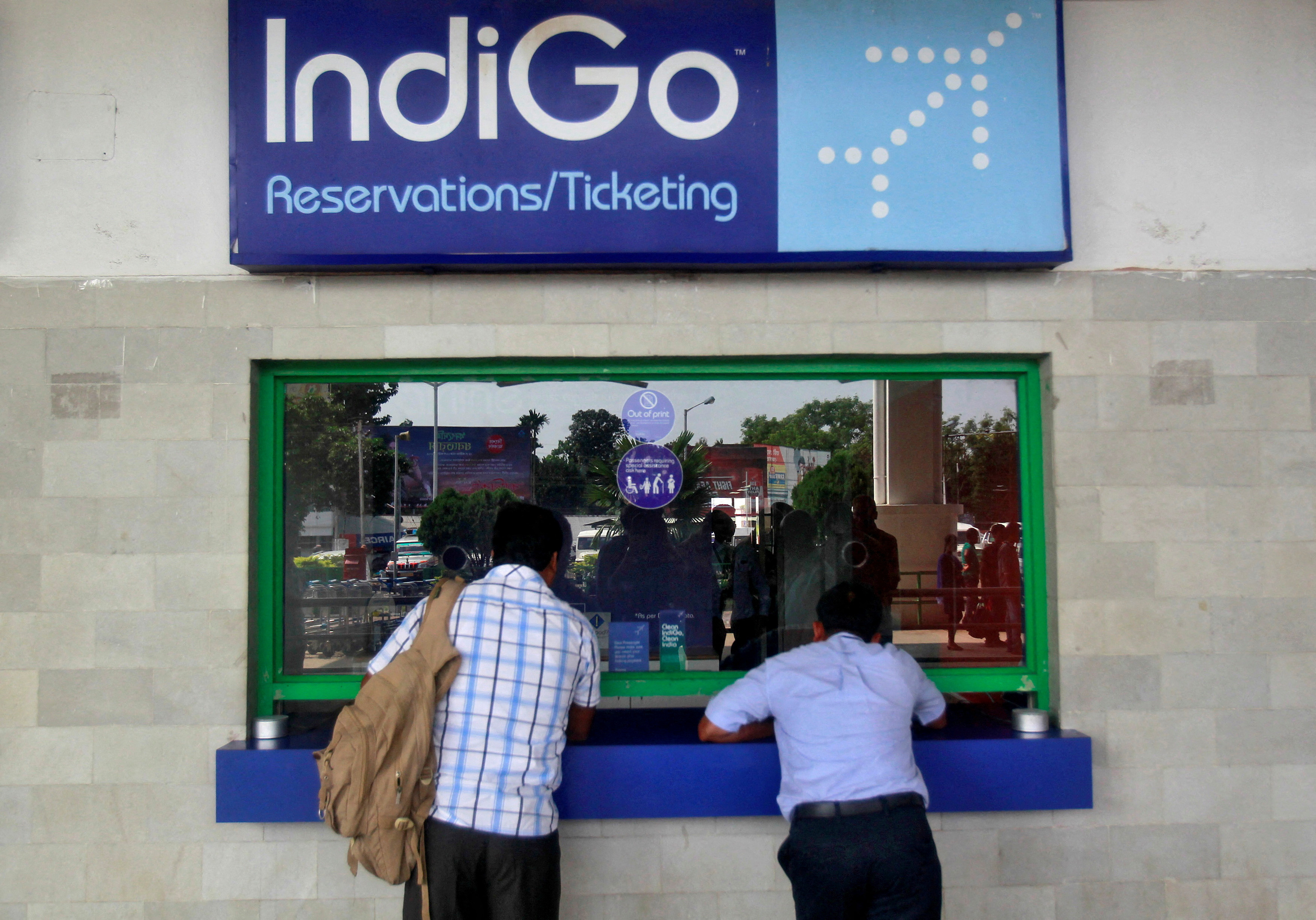 Passengers stand at the ticket counter of Indigo Airlines at the airport on the outskirts of Agartala