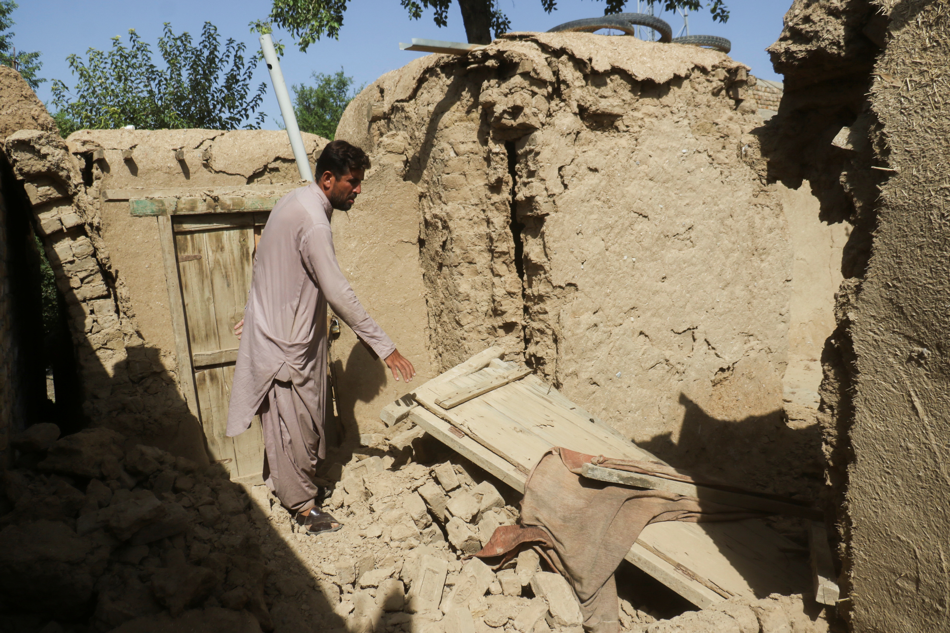 A resident removes damaged parts of his house following an earthquake in Harnai, Balochistan, Pakistan, October 7, 2021. REUTERS/Naseer Ahmed