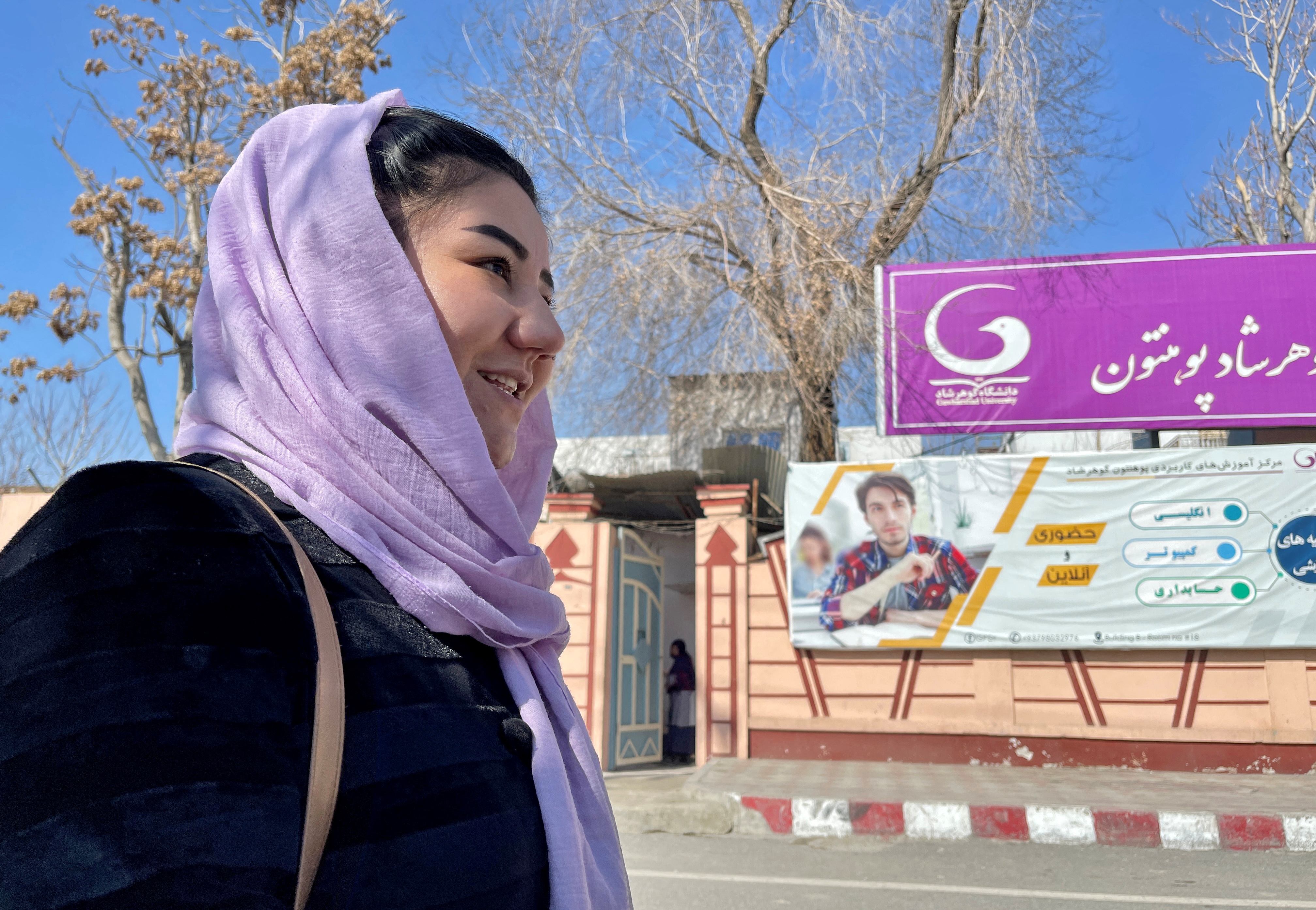 Waheeda Bayat, a 24-year-old student, stands outside Gawharshad University in Kabul, Afghanistan February 24, 2022. REUTERS/Stringer