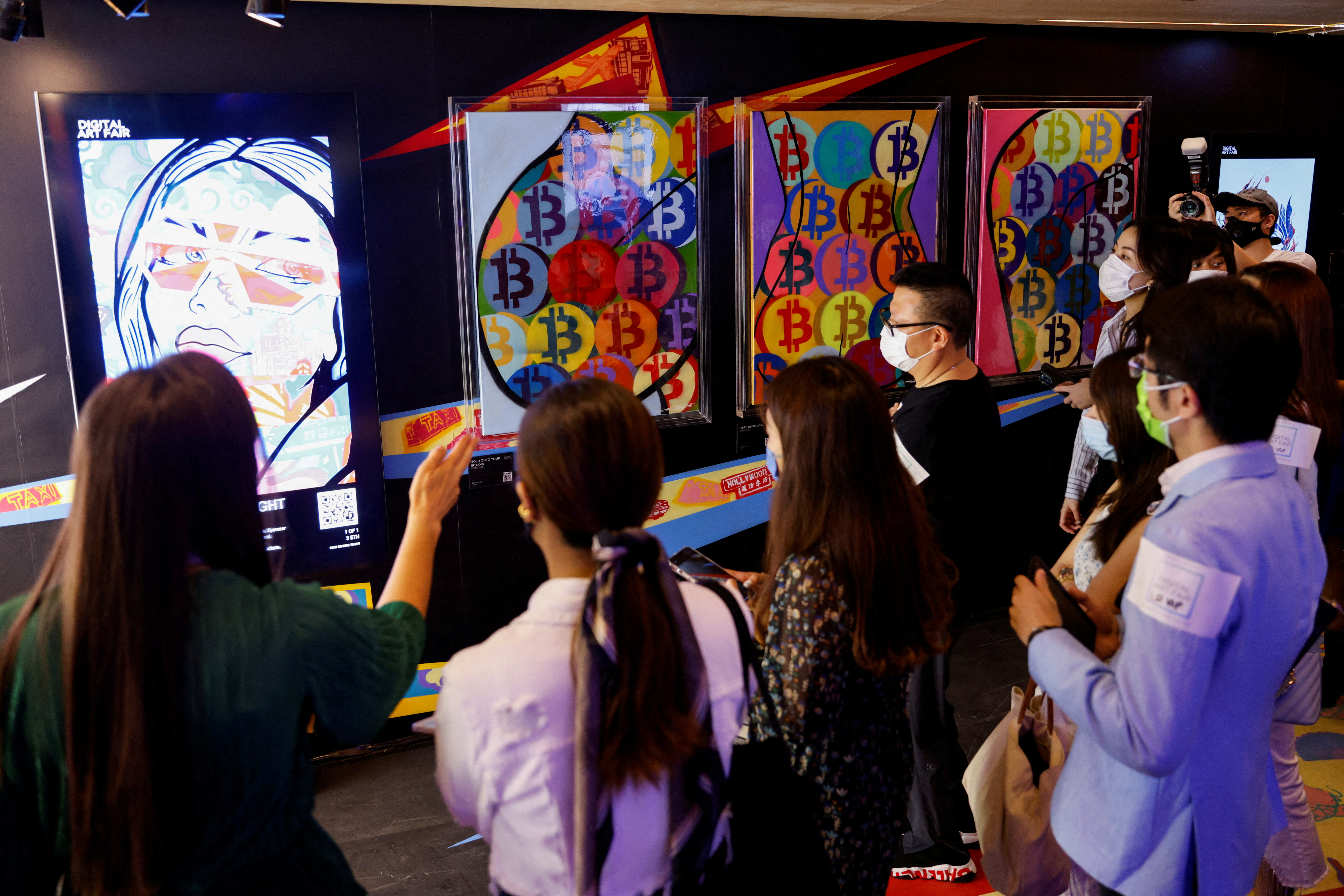 Visitors walk in front of an artwork which will be converted into NFT and auctioned online at Sotheby's, in Hong Kong