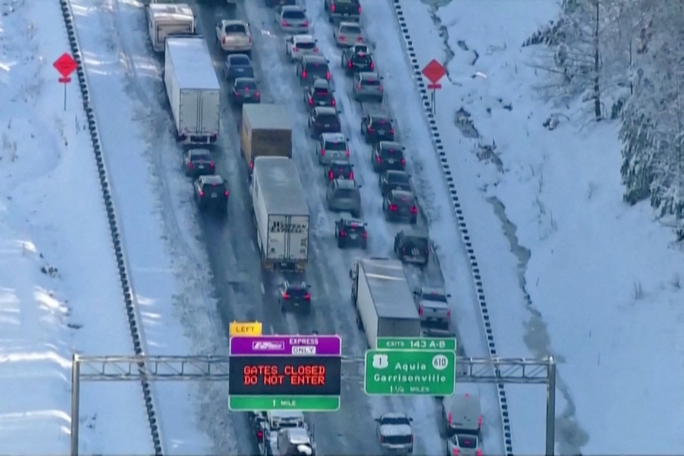 Vehicles are seen in a still image from video as authorities worked to reopen an icy stretch of Interstate 95 closed after a storm blanketed the U.S. region in snow a day earlier, near Garrisonville, Virginia, U.S. January 4, 2022.  ABC/WJLA via REUTERS   