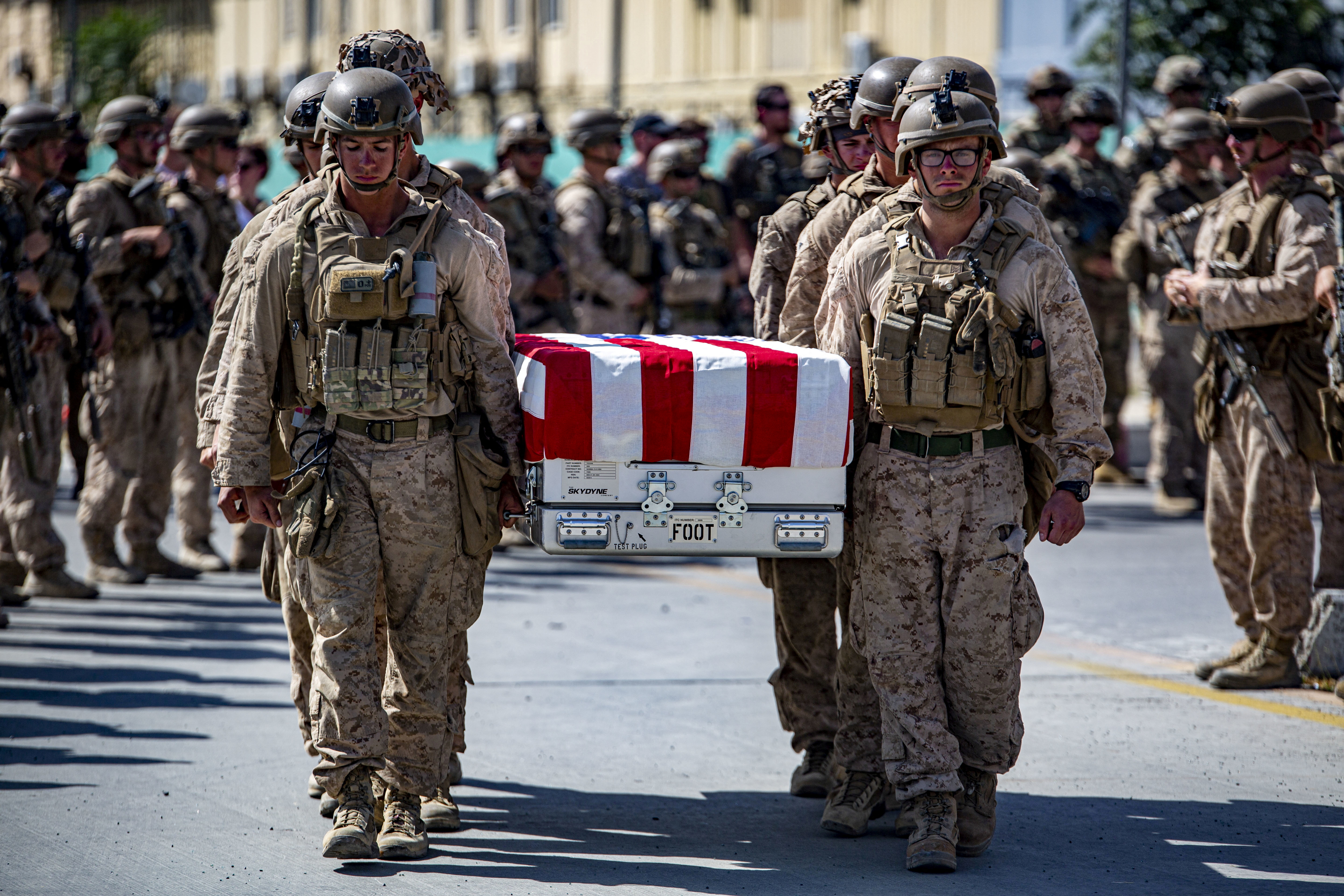 U.S. service members act as pallbearers for the service members killed in action in Kabul