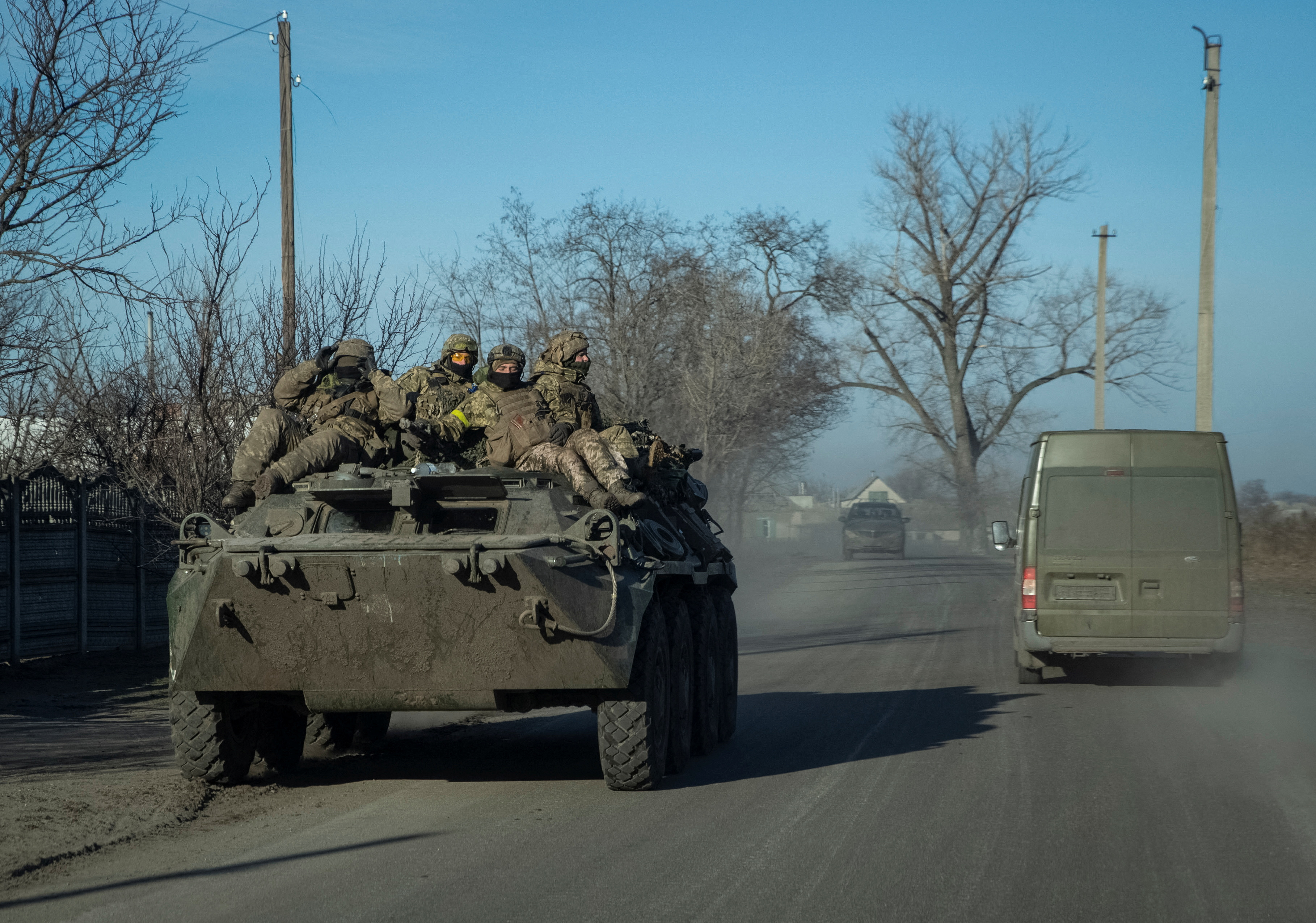 Ukrainian servicemen ride an Armoured Personnel Carrier in Lyman