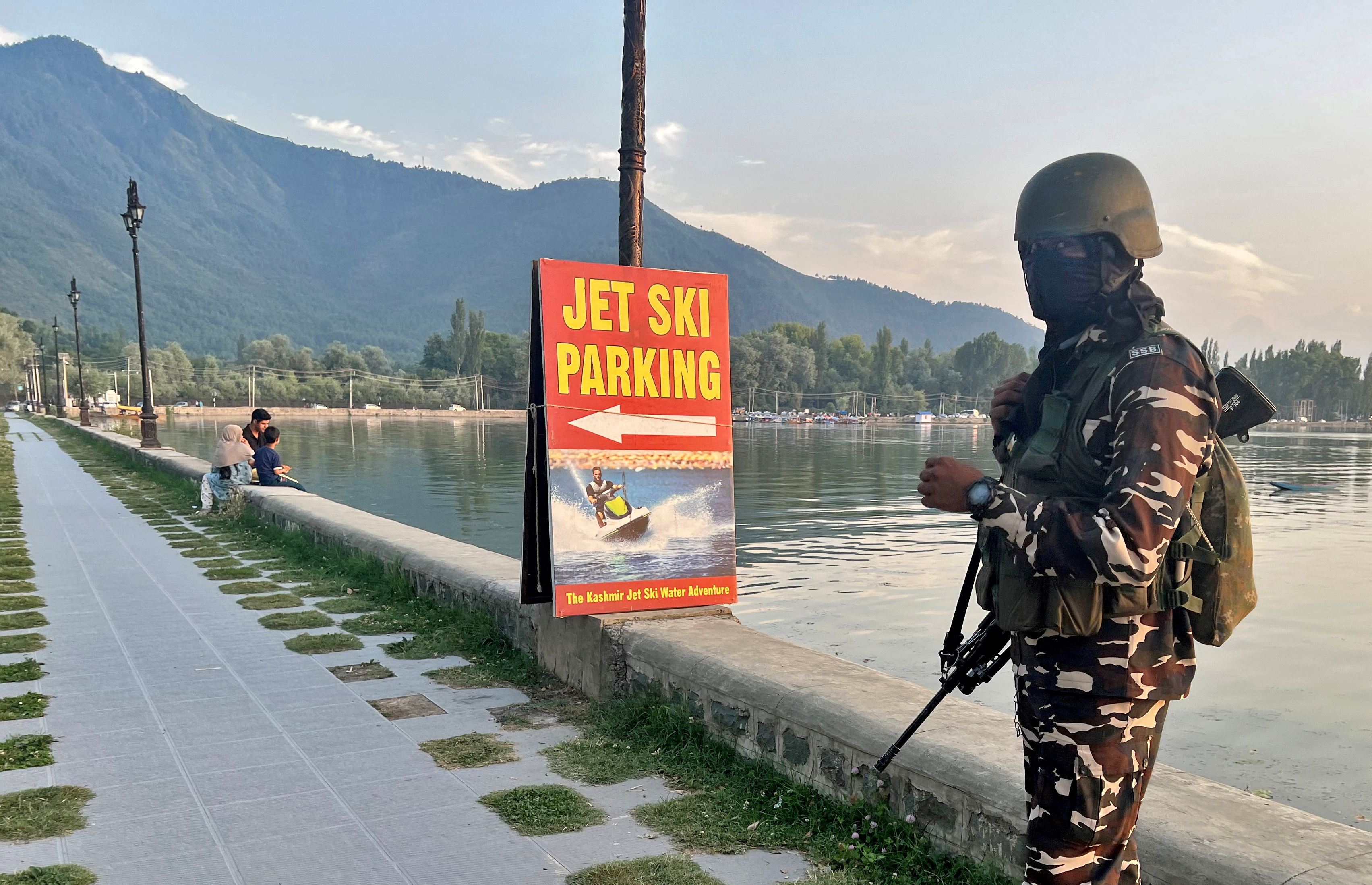 An Indian security force personnel stands guard on the banks of Dal Lake in Srinagar