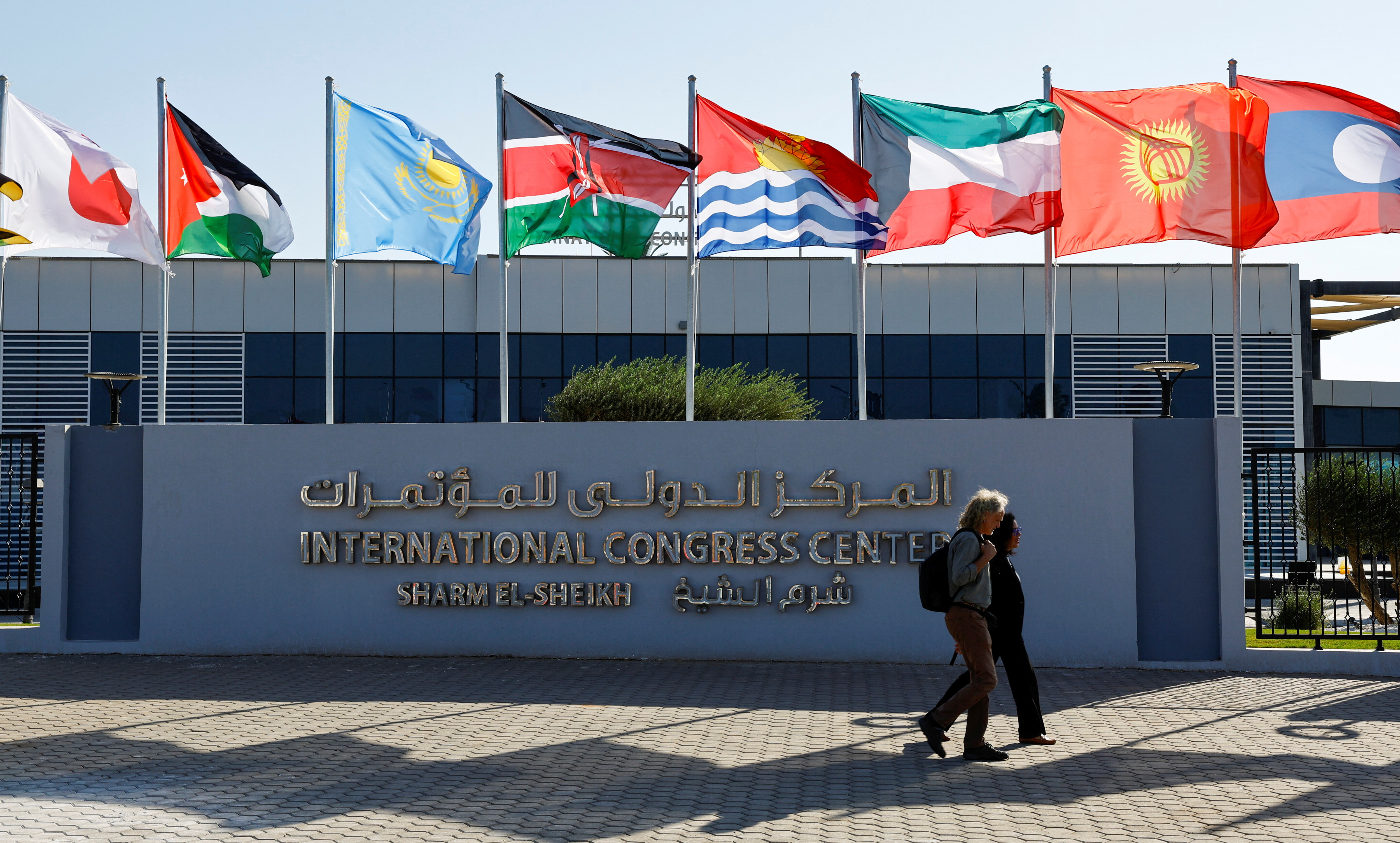 Participants walk outside of the Sharm El Sheikh International Convention Centre before the COP27 climate summit opening in Sharm el-Sheikh