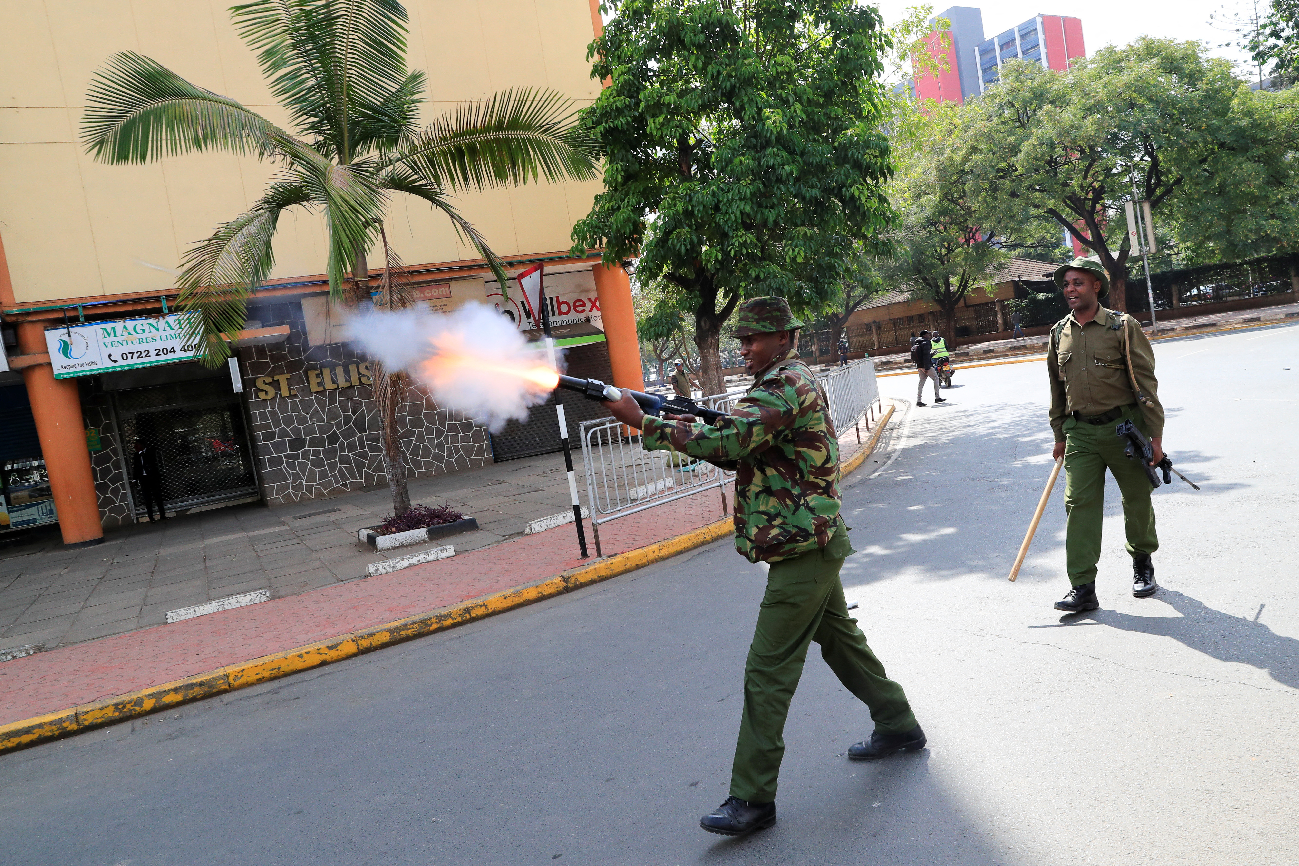 Riot police officer fires teargas to disperse supporters of Kenya's opposition leader Raila Odinga of the Azimio La Umoja (Declaration of Unity) One Kenya Alliance, during protests in Nairobi