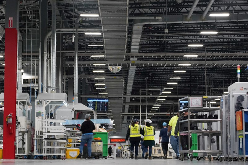 Employees work on solar panels at the QCells solar manufacturing factory in Dalton