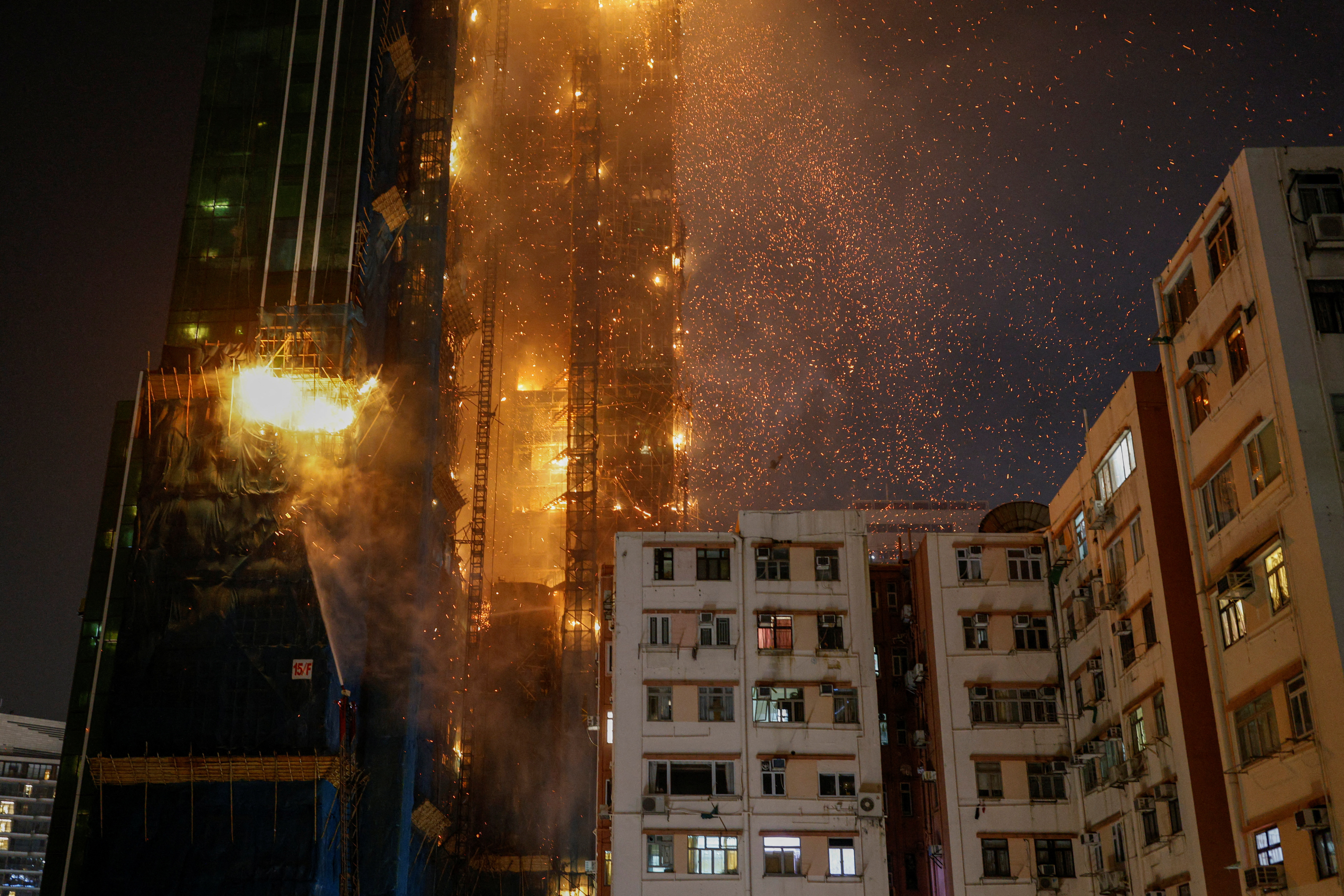 An under-construction skyscraper is seen on fire at Tsim Sha Tsui in Hong Kong