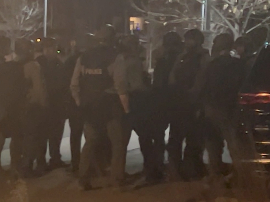 Officers gather in the street in Lakewood, Colorado, U.S., December 27, 2021 in this still image taken from a social media video. Hawk Hawkins/via REUTERS