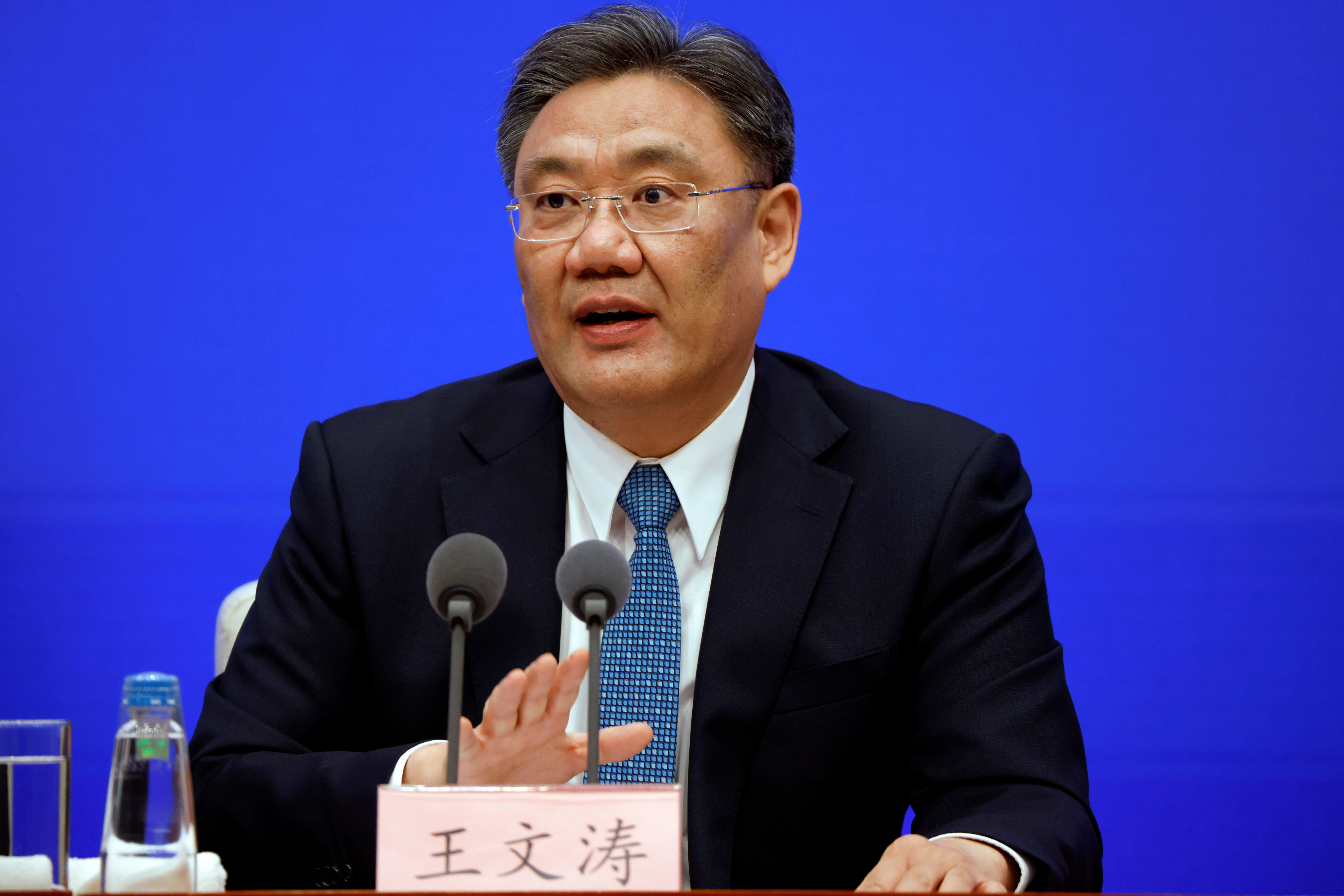 Chinese Commerce Minister Wang Wentao attends a State Council Information Office news conference in Beijing